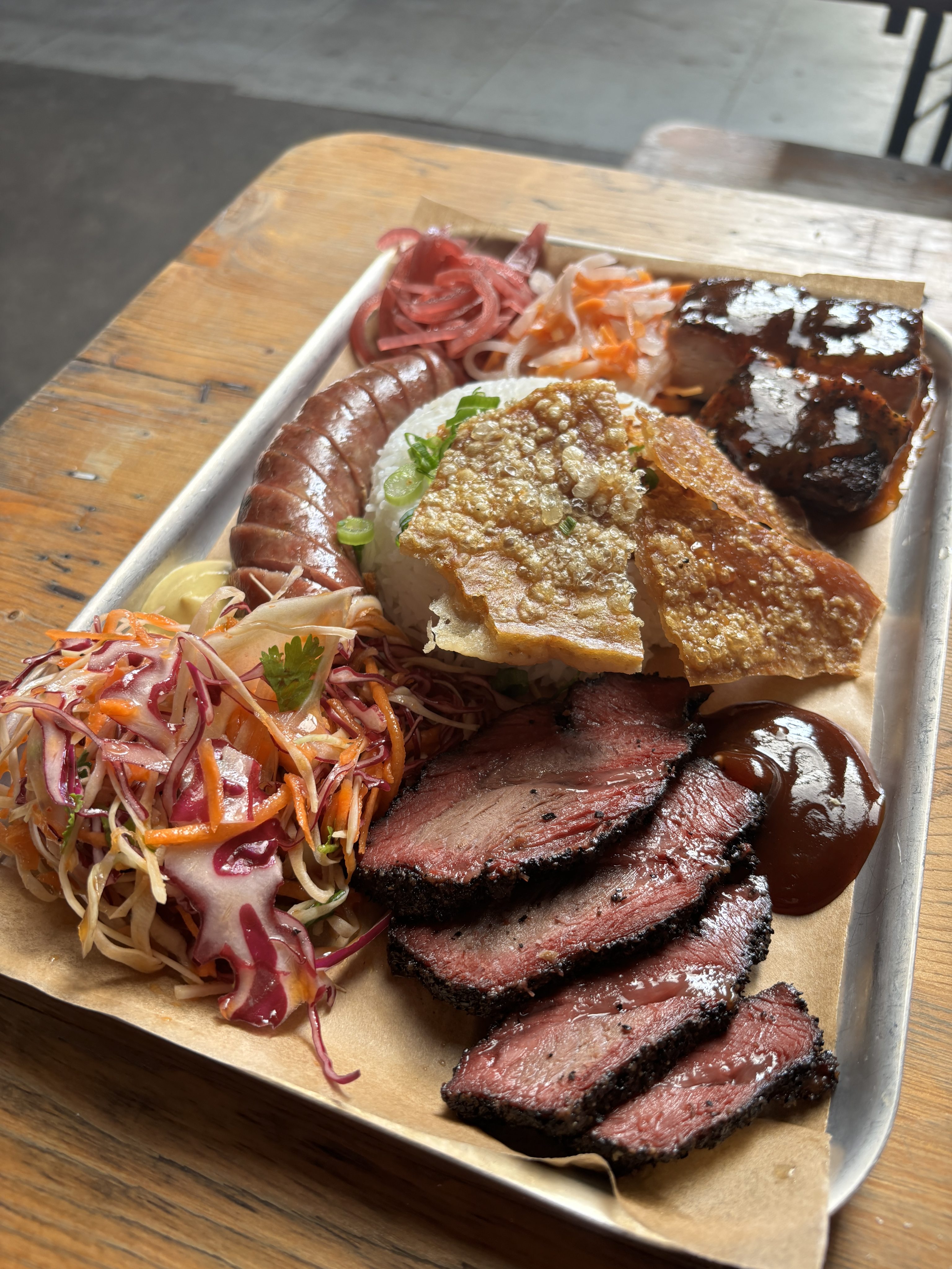 A mixed meat barbecue platter from Uncle Hon’s. The brisket (front right) shows the requisite “smoke ring” that barbecue fans look out for. Photo: Angela Hui