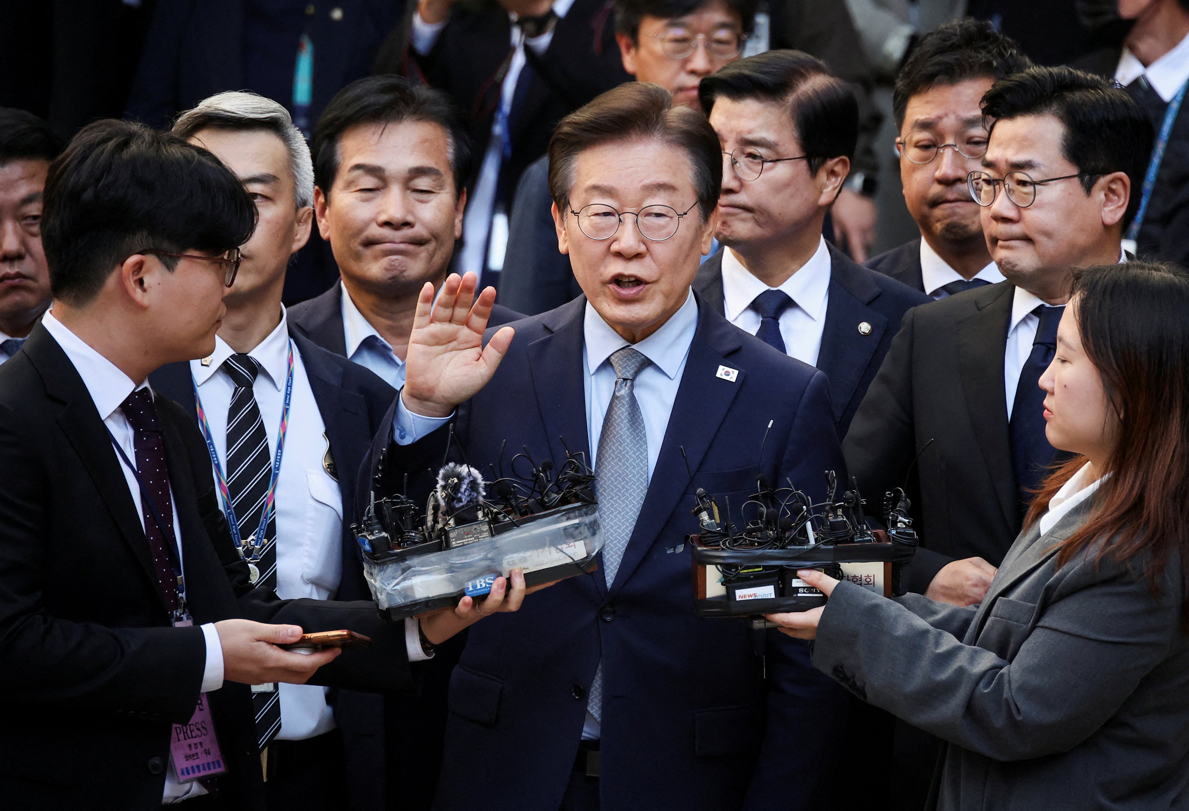 South Korea’s main opposition Democratic Party Leader Lee Jae-myung speaks as he leaves court on Friday after being convicted on charges of violating election law. Photo: Reuters