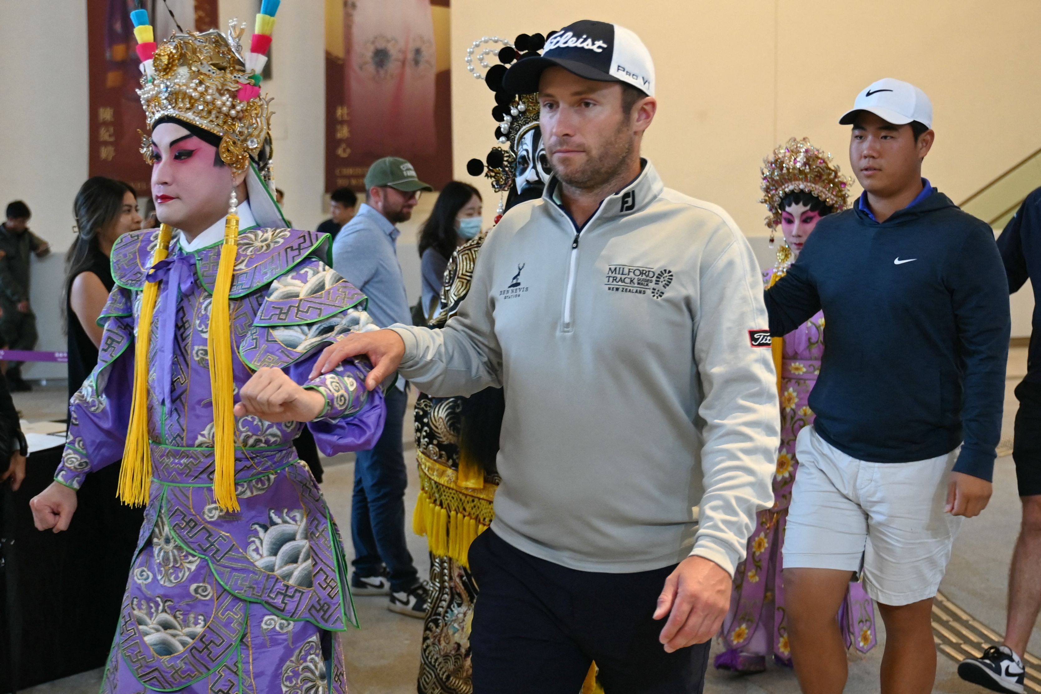 Defending champion Ben Campbell heads into a Hong Kong Open press conference with a Chinese opera singer. The Kiwi reckons the race will not be decided until the Saudi leg of the International Series. Photo: AFP