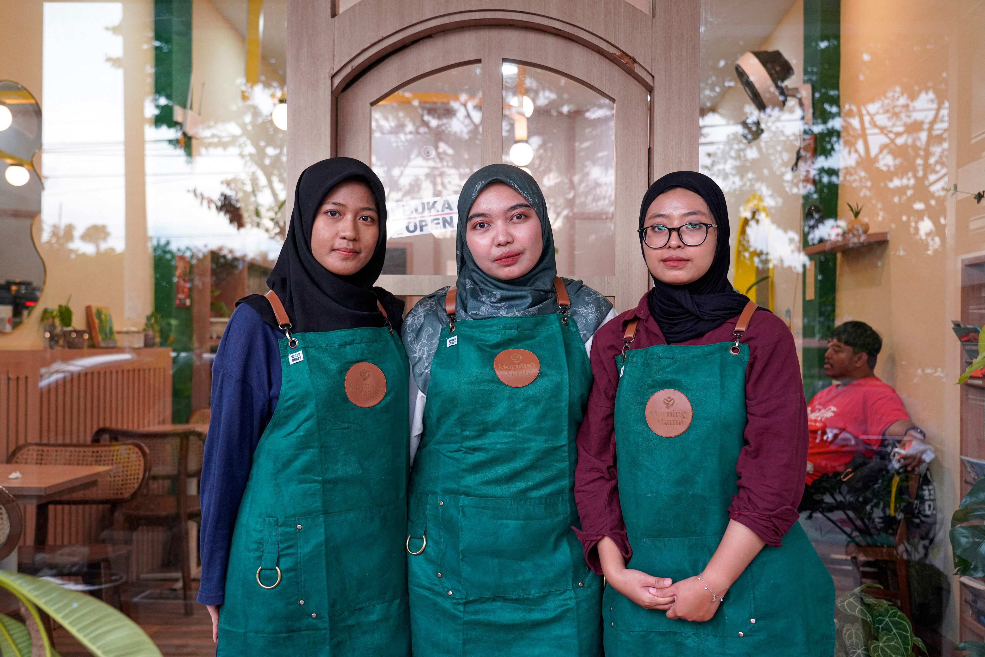 Qurrata Ayuni (centre), owner of Morning Mama, a coffee shop in Indonesia’s conservative Aceh province, with two of her staff. The cafe creates a space for women in a city where coffee shops have long catered to men. Photo: AFP