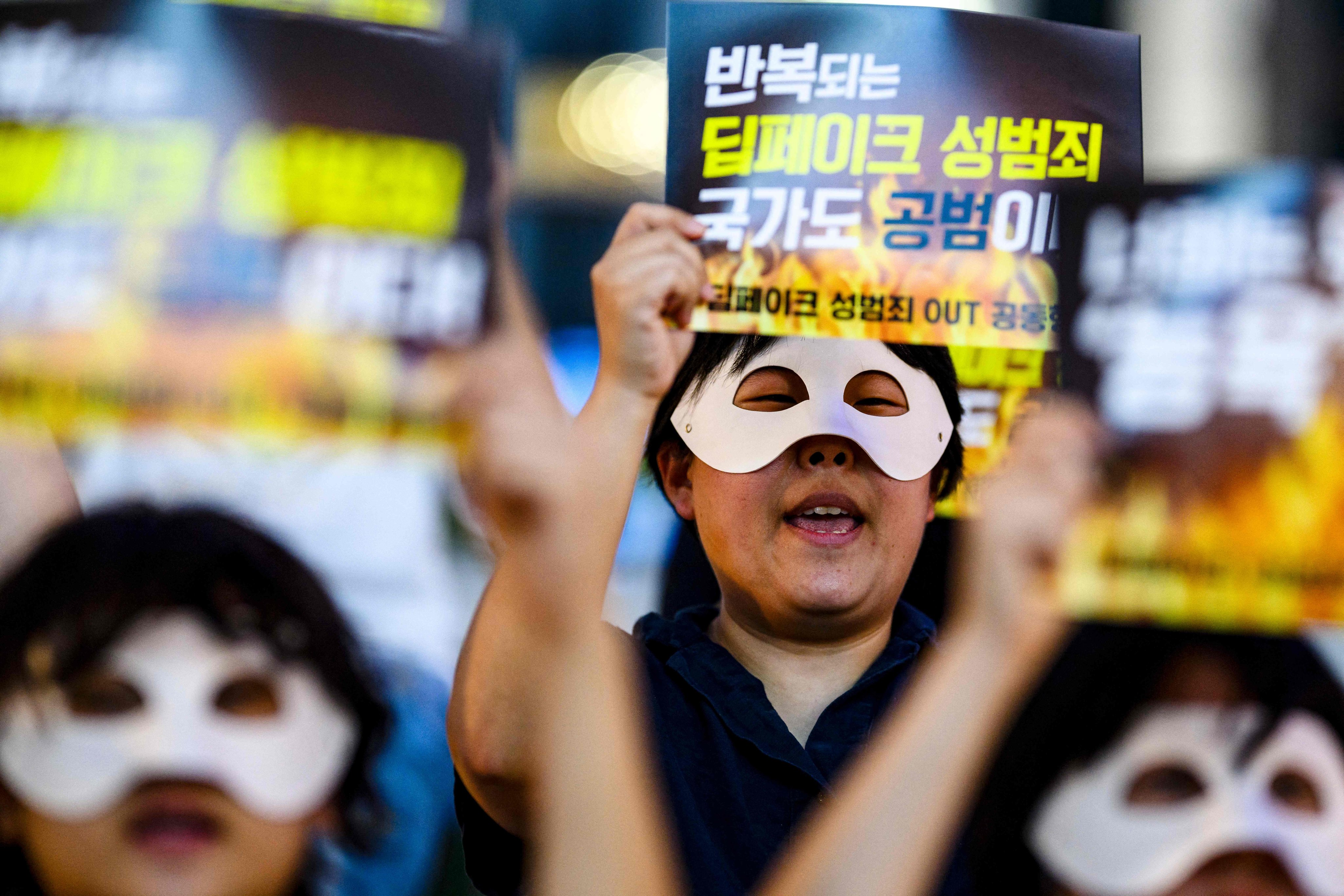 Activists hold posters reading “Repeated deepfake sex crimes, the state is an accomplice too’”during a protest against deepfake porn in Seoul. Photo: AFP