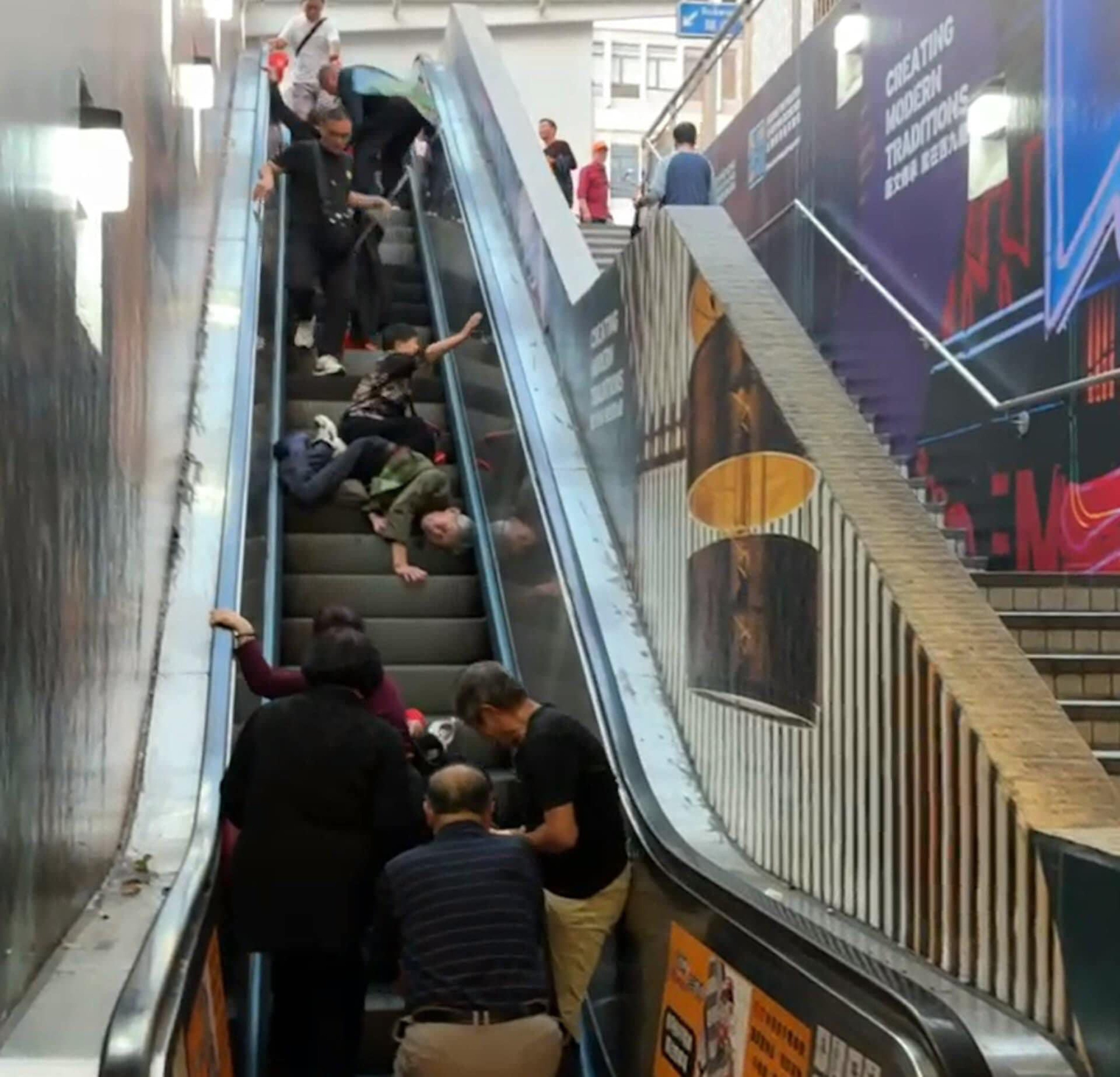 A video circulating online showed several people sprawled on a halted escalator at an exit of the East Tsim Sha Tsui MTR station in Hong Kong. Photo: SCMP