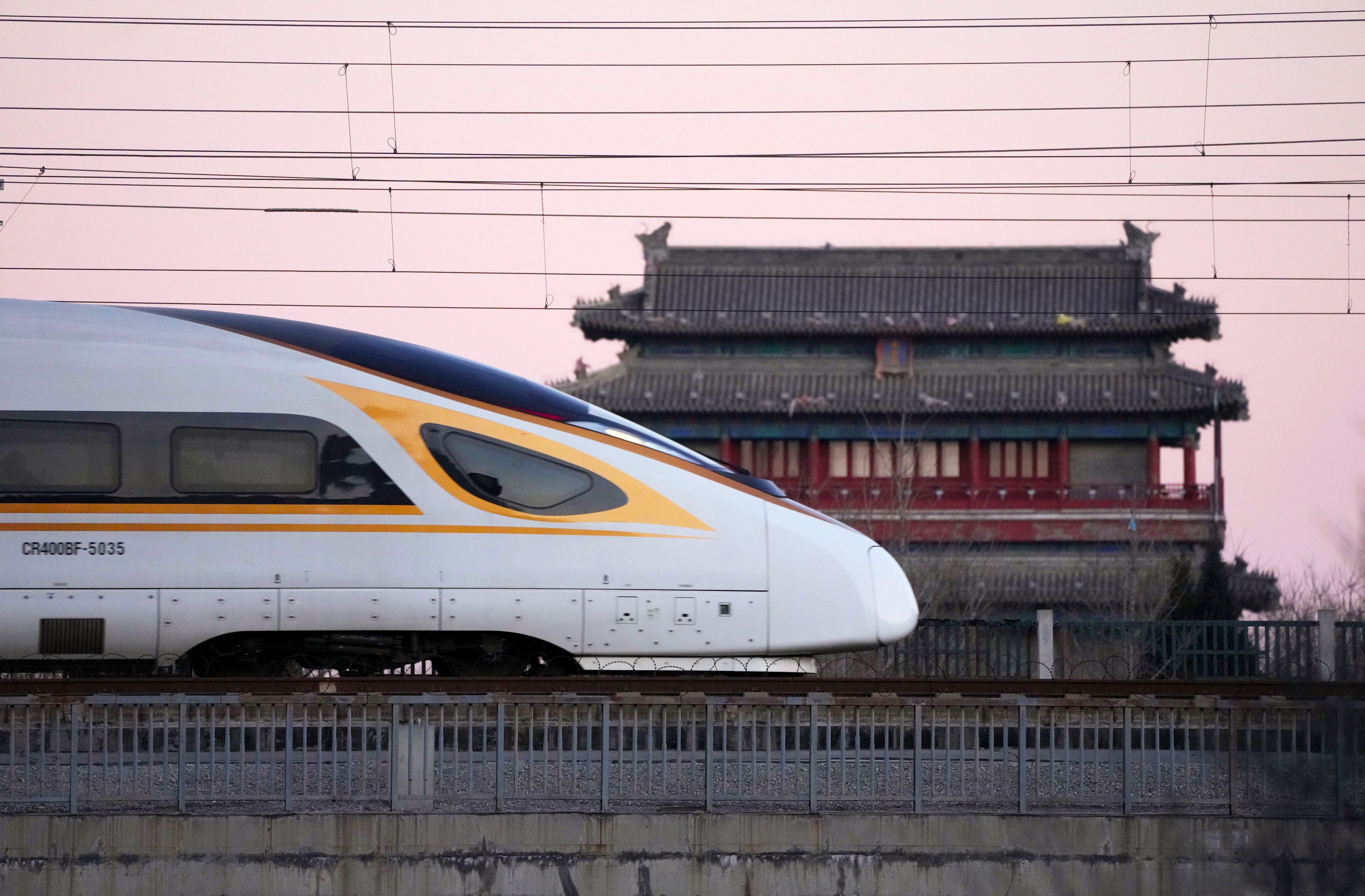 A bullet train passes by the Yongdingmen, the Gate of Perpetual Peace in Beijing. Photo: Xinhua