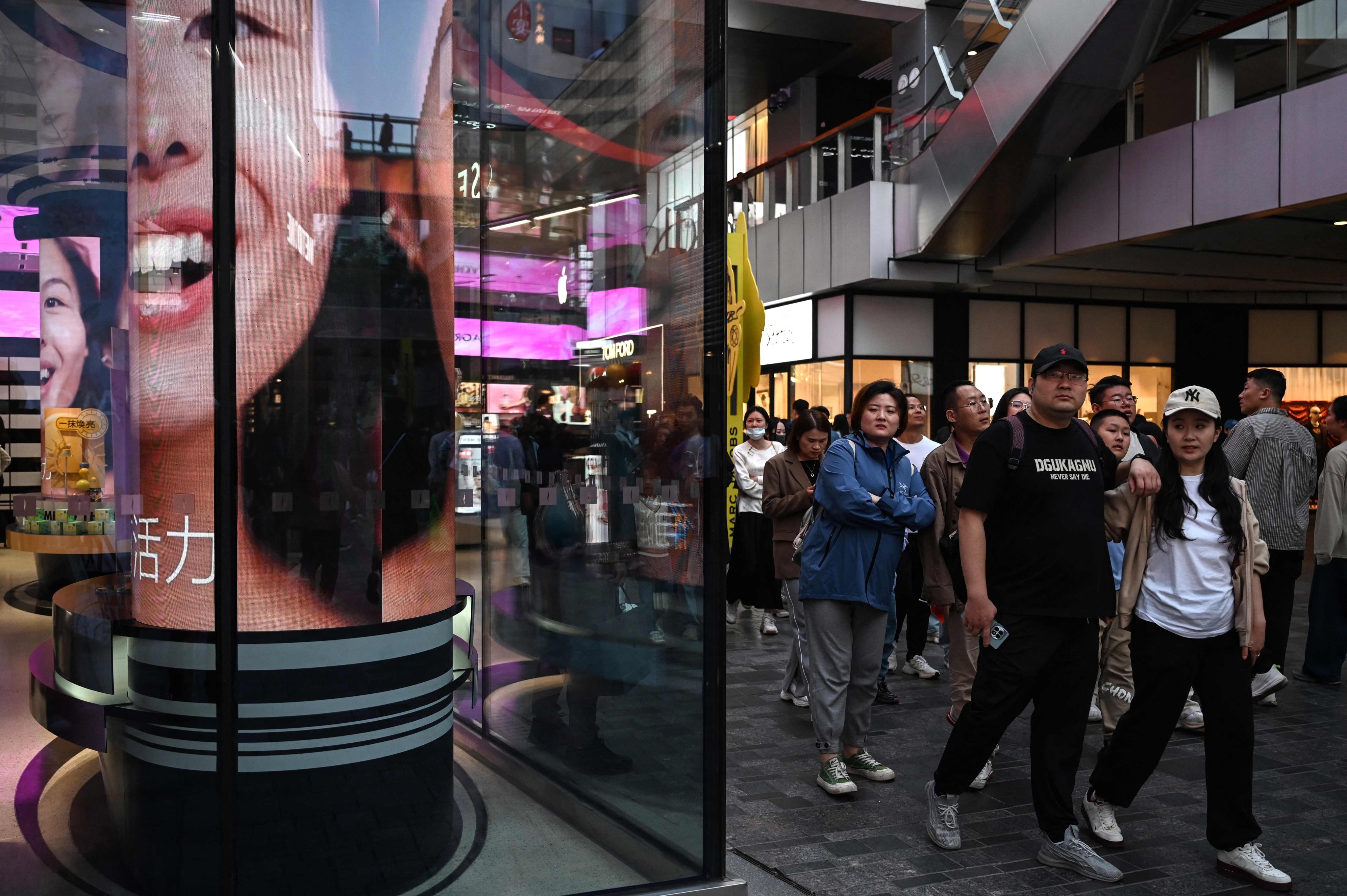 People in a shopping mall in Beijing. Photo: AFP