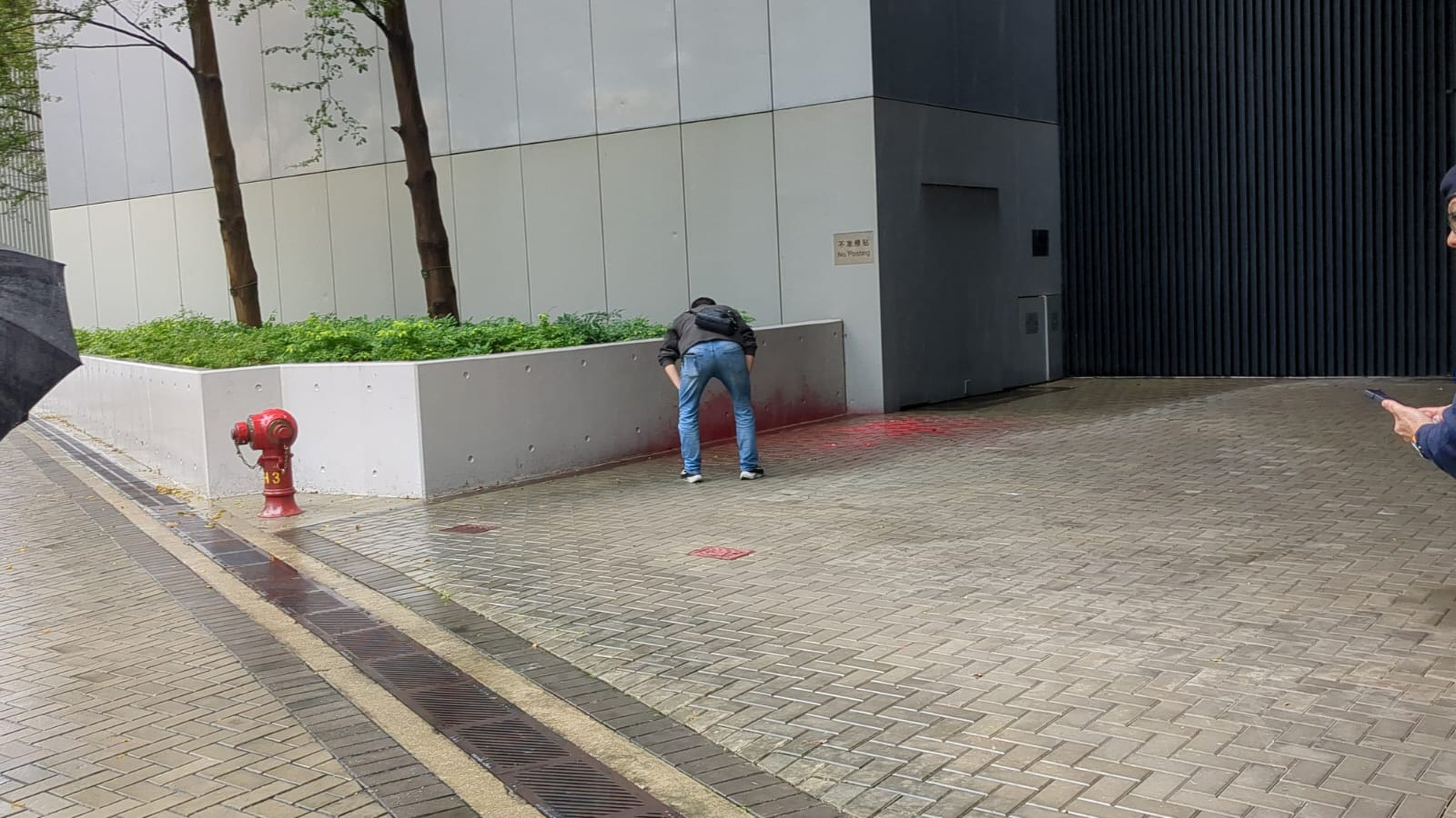 Security personnel discovered the paint splashed near a flower bed at an entrance of the headquarters close to Harcourt Road on Wednesday morning. Photo: Handout 