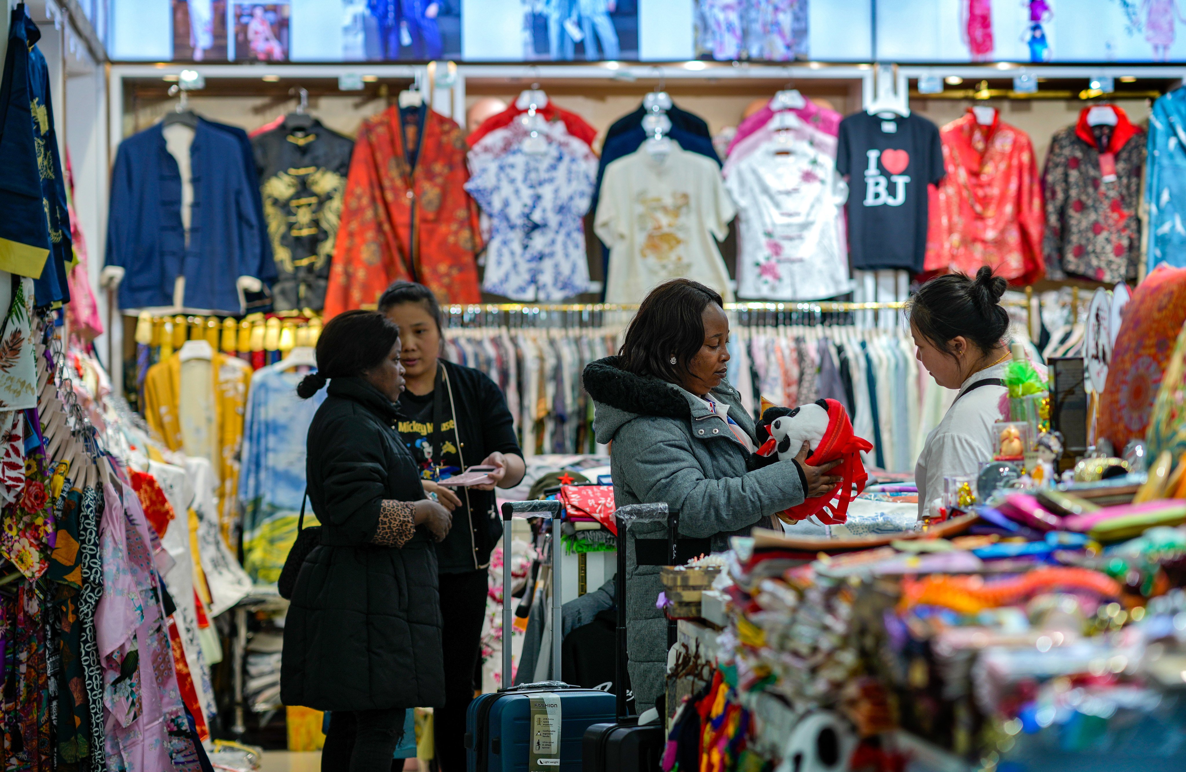 Foreign tourists shop for clothing and souvenirs at Hongqiao Market in Beijing. Photo: AP