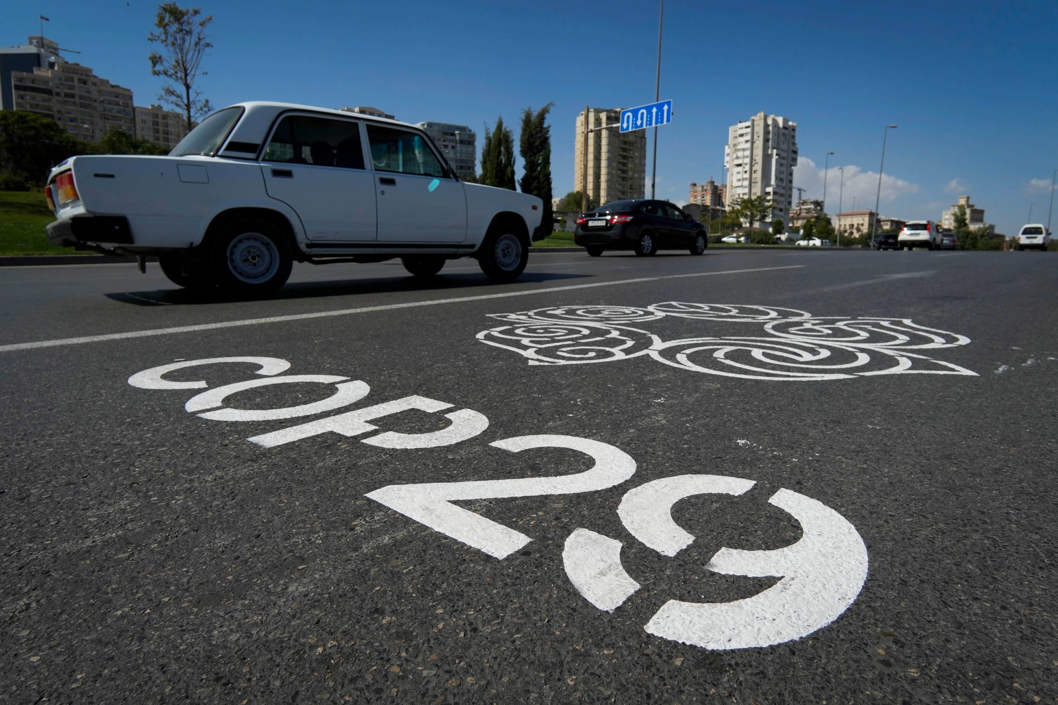 Motorists drive by the logo for the United Nations Climate Change Conference (Cop29), painted on a road in Baku, Azerbaijan, on September 16. Photo: AP