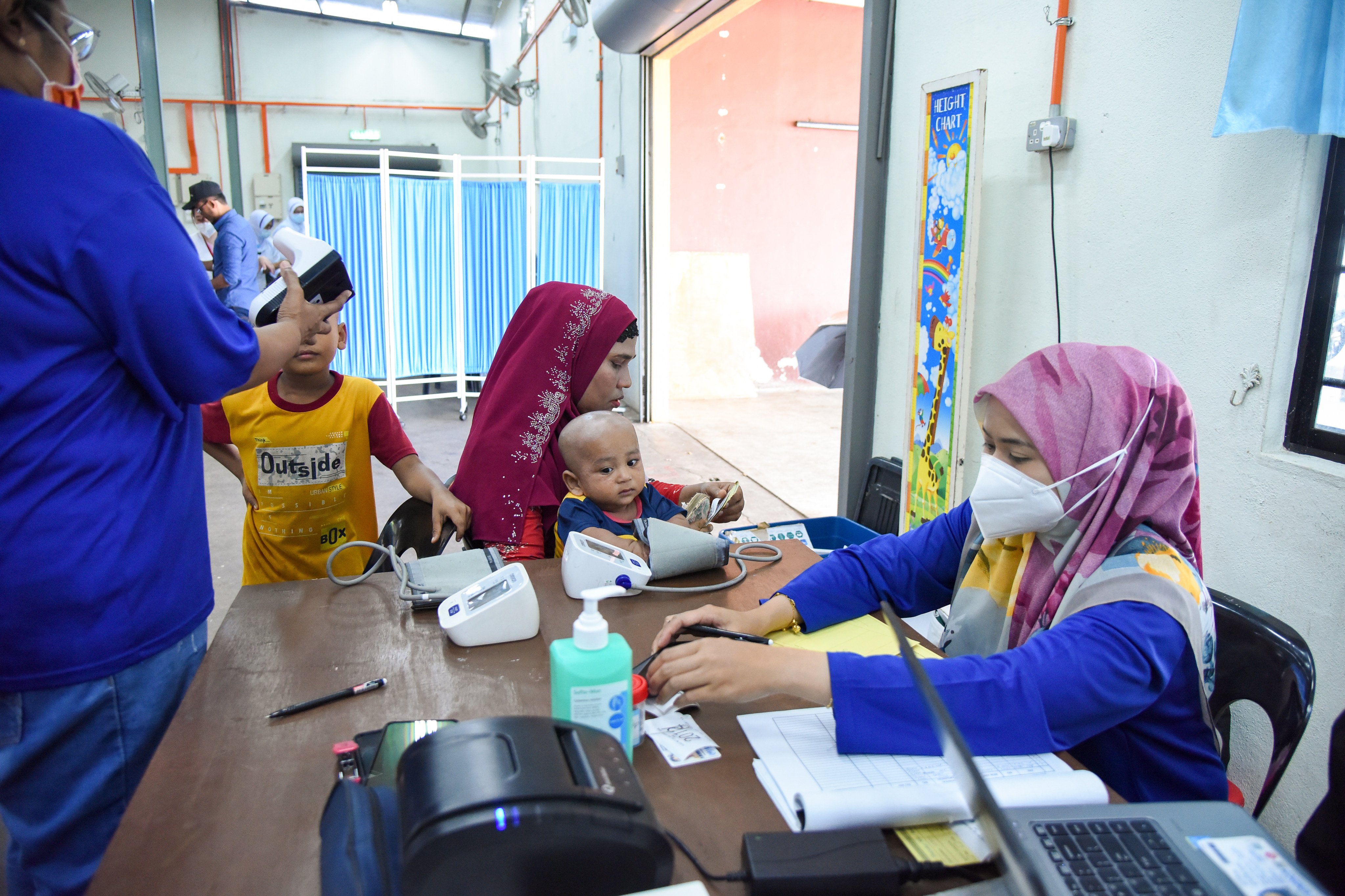 Nor Anis Syazwani collects preliminary health data upon patients’ arrival at an MSF mobile clinic in Penang, Malaysia. Photo: Steven Ooi/MSF