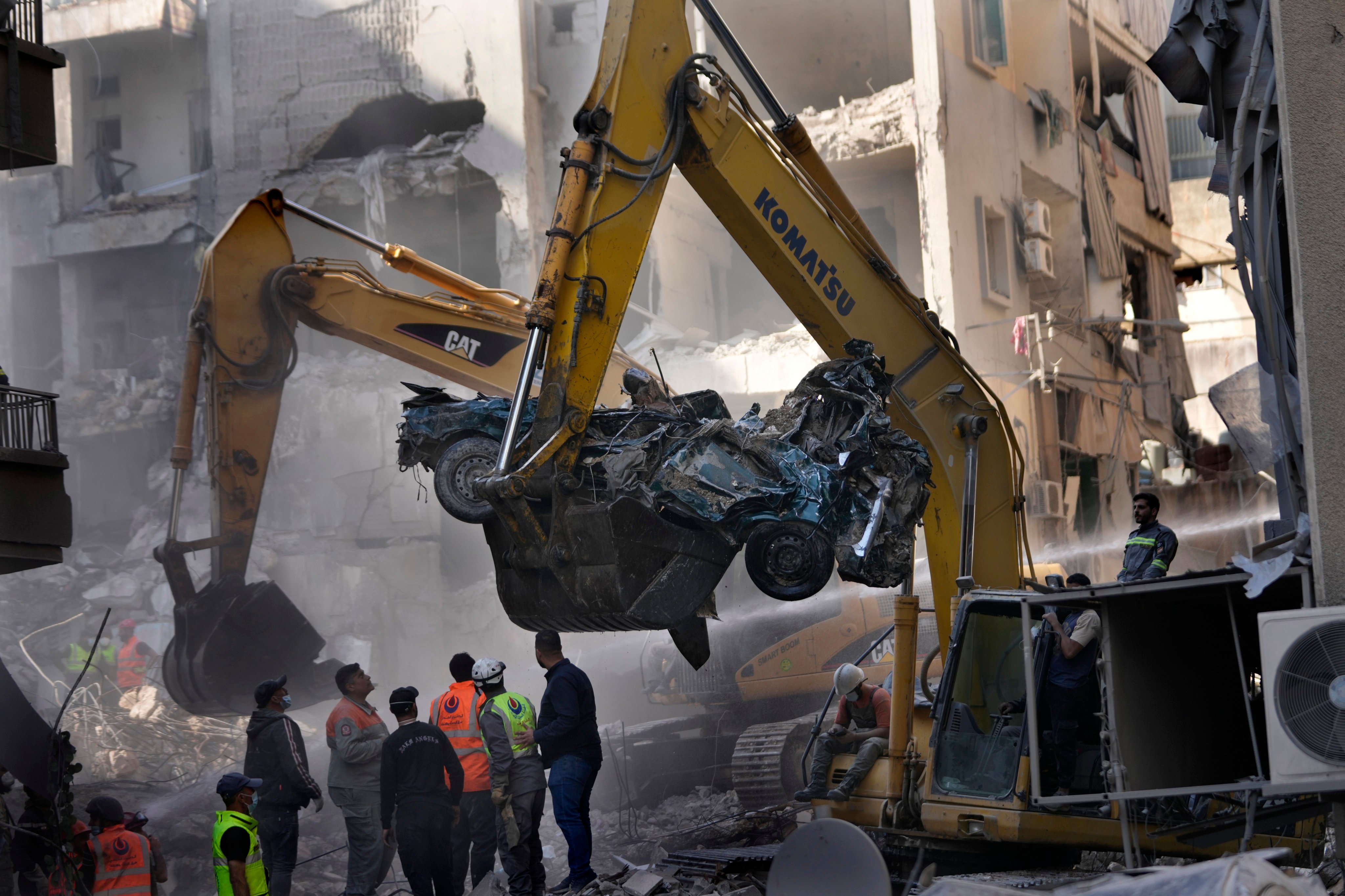 An excavator removes a destroyed car as rescue workers gather at the site of an Israeli airstrike that hit central Beirut, Lebanon, on Saturday. Photo: AP