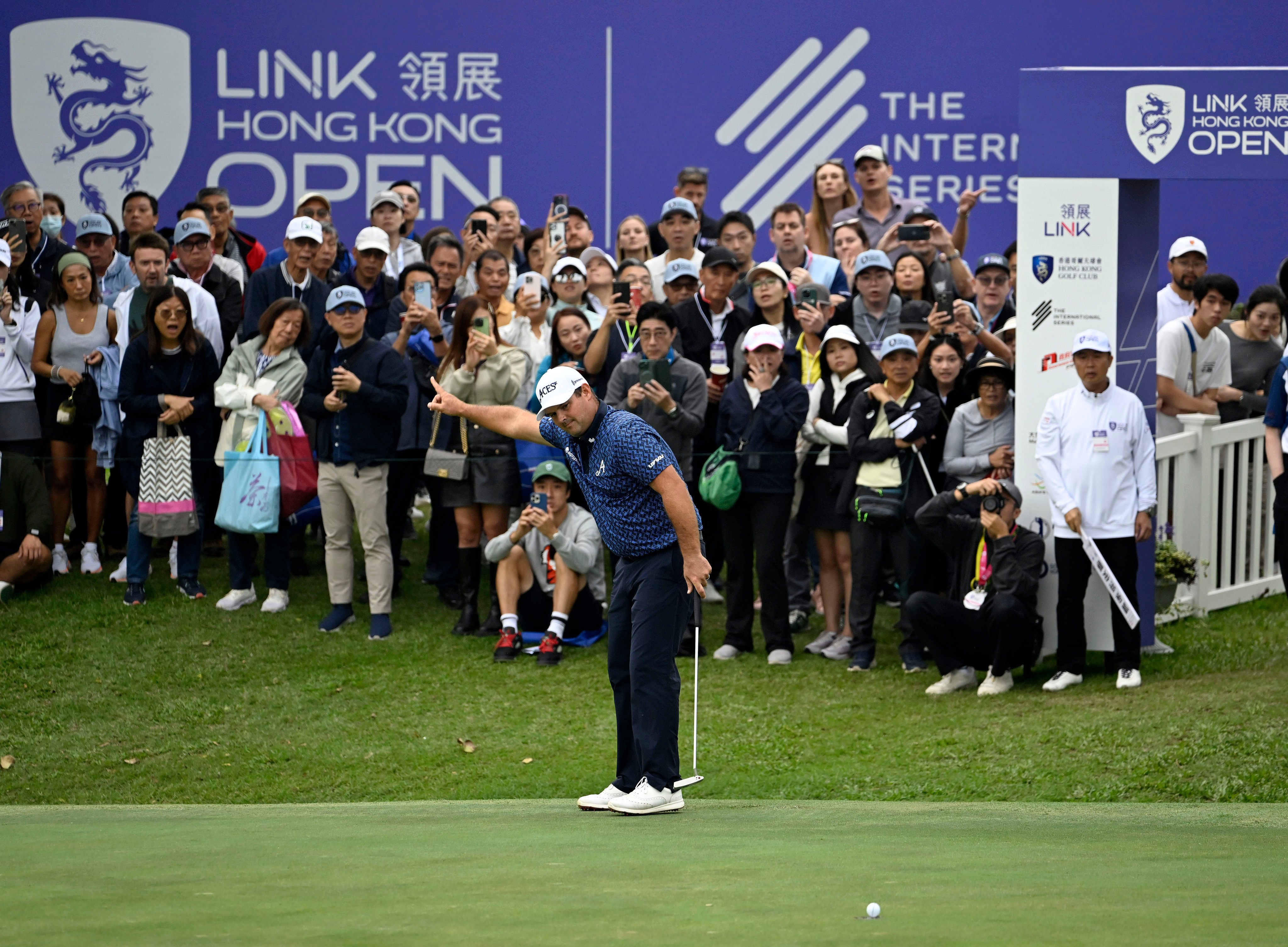 Patrick Reed starts celebrating as his birdie putt heads to the hole on the 18th during the third round of the Link Hong Kong Open. Photo: Asian Tour.