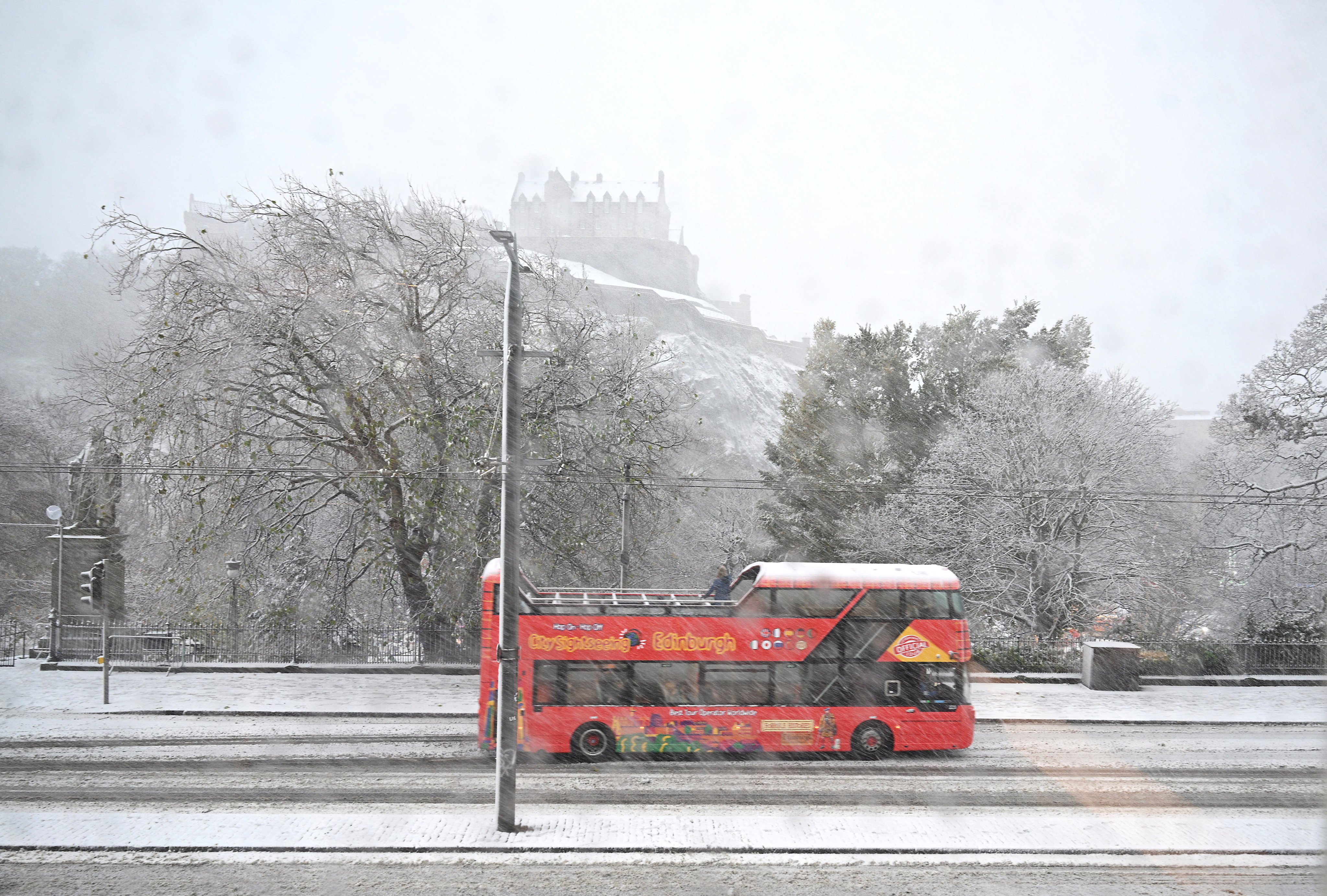 A tour bus drives through heavy snowfall during Storm Bert, along Princes Street in Edinburgh, Scotland, Britain, on Saturday. Photo: Reuters