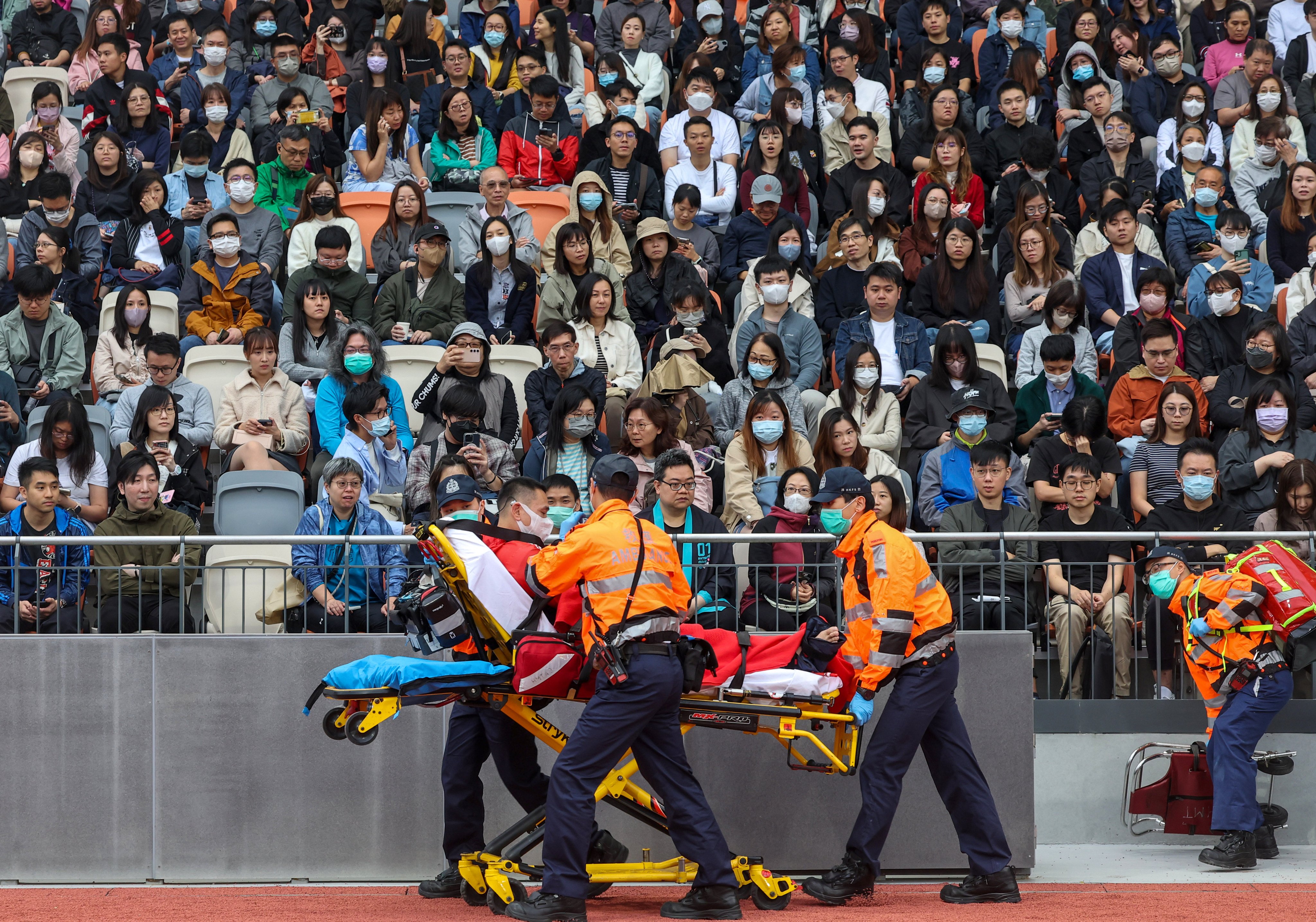 Emergency responders rush a man to safety during a five-hour drill exercise. Photo: Edmond So