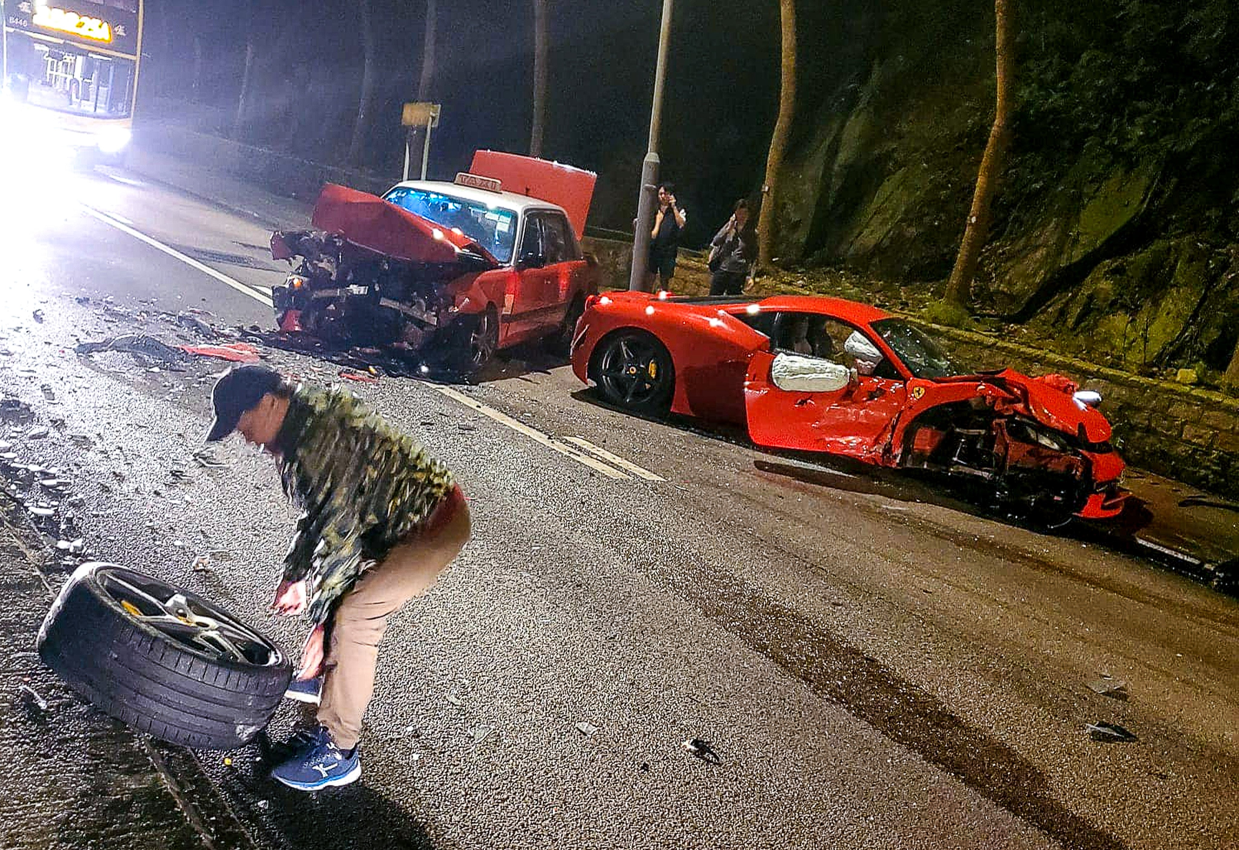 An image from the internet shows the Ferrari and taxi badly damaged on the debris-strewn road in Braemar Hill. Photo: Facebook