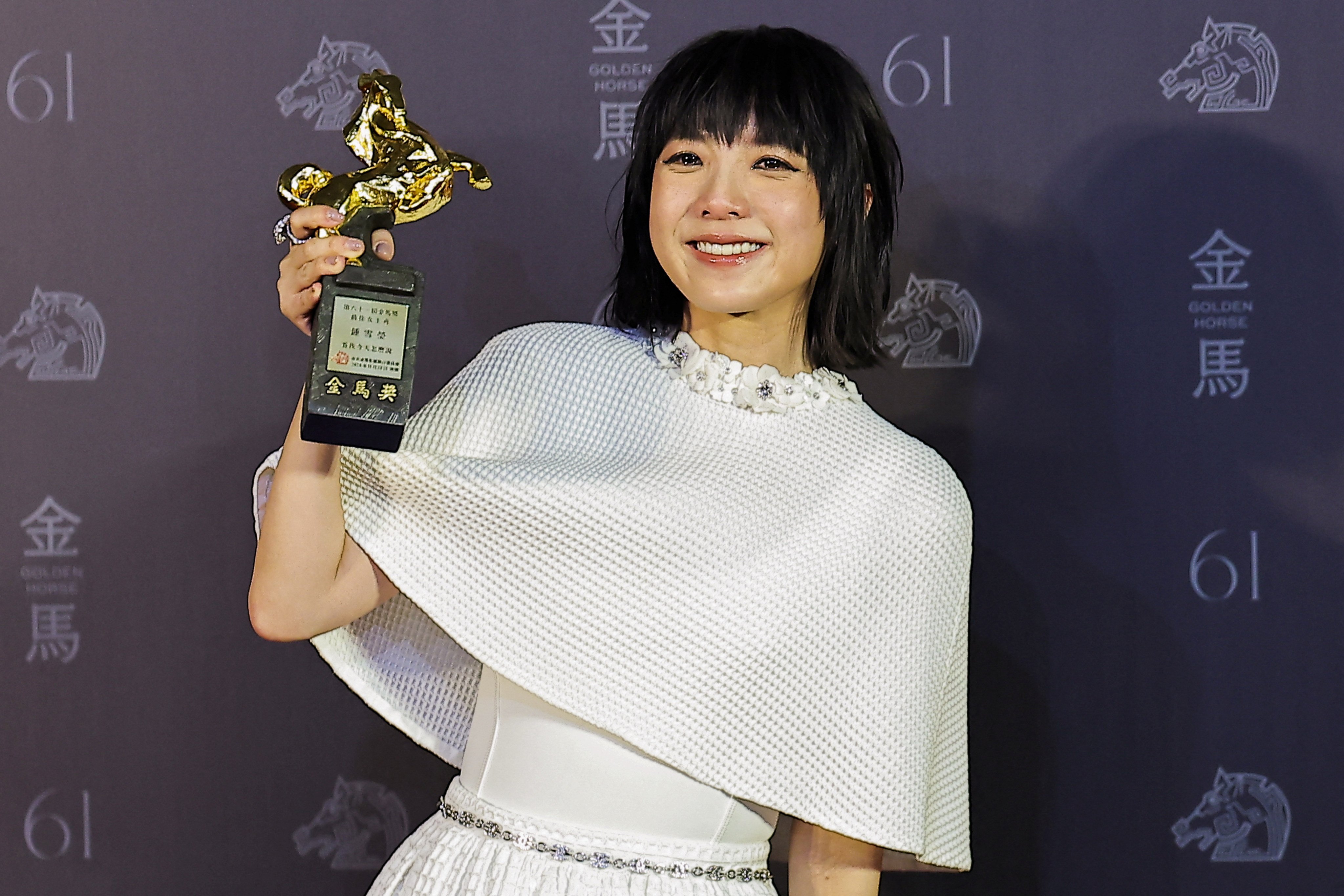 Chung Suet-ying poses with her best actress award in Taipei. Photo: Reuters 