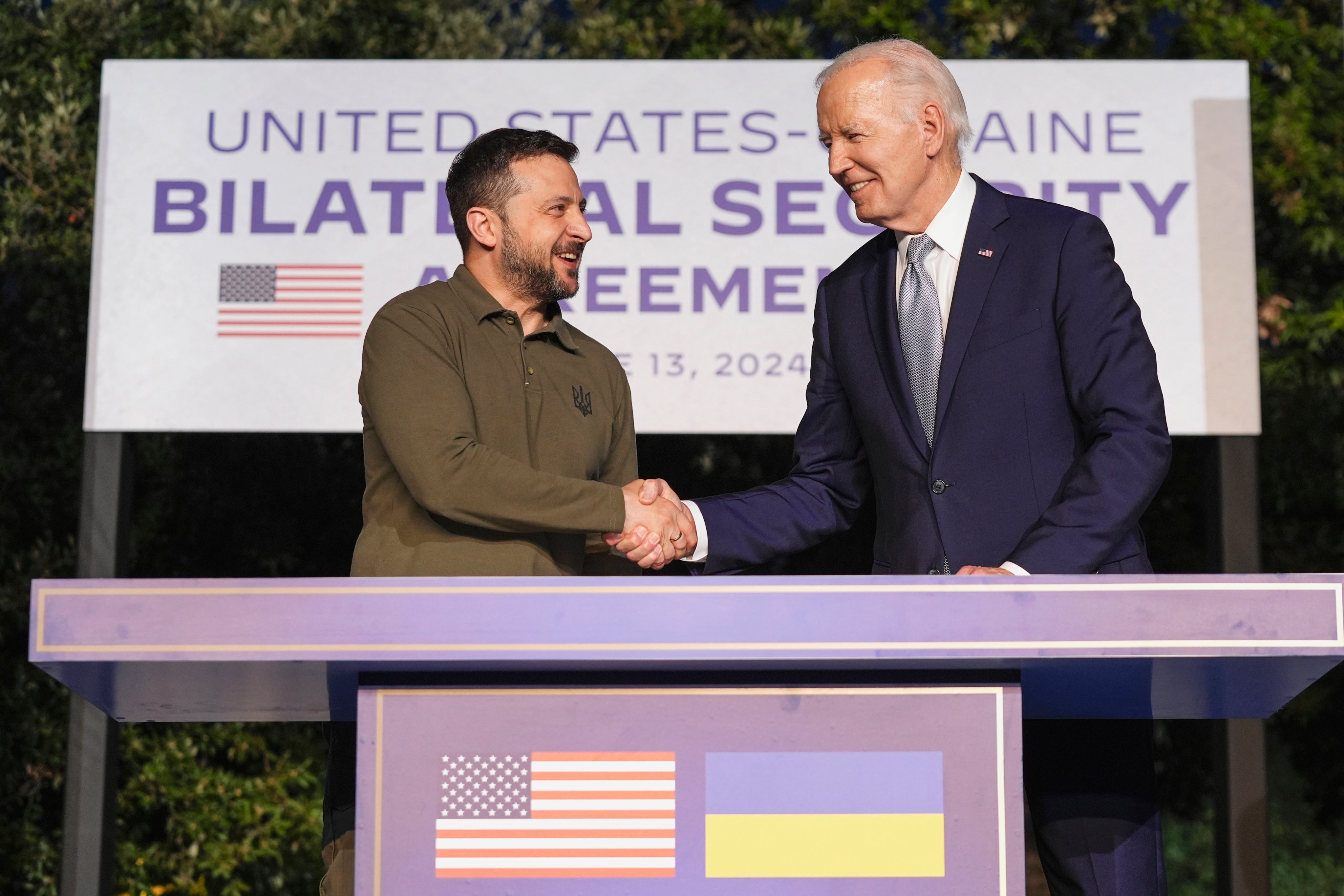 US President Joe Biden and Ukrainian President Volodymyr Zelensky shake hands after signing a security agreement on the sidelines of the G7 in June. Photo: AP