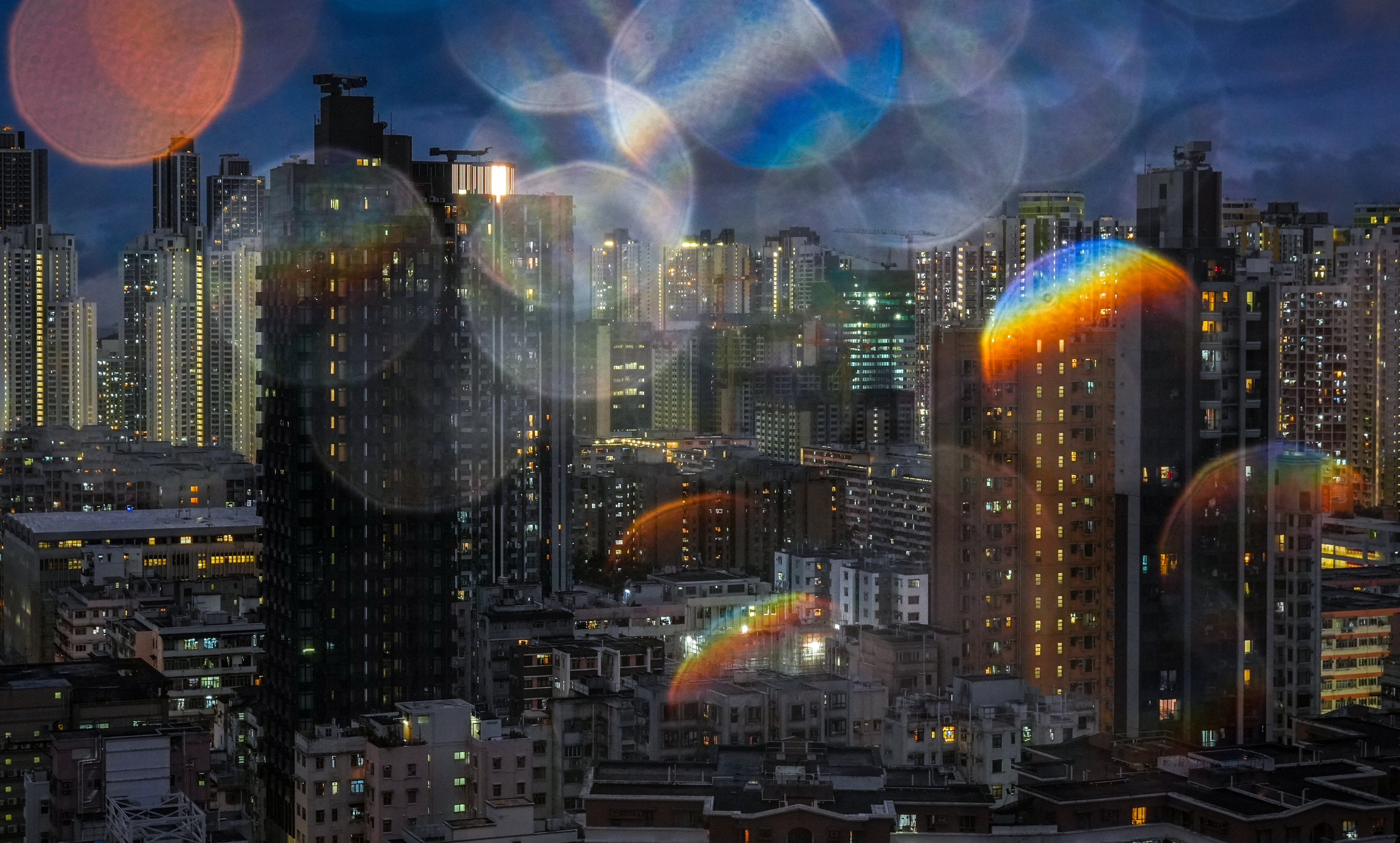 Raindrops on the camera lens refract a night view of Hong Kong’s Sham Shui Po district on November 19, 2024. Photo: Eugene Lee