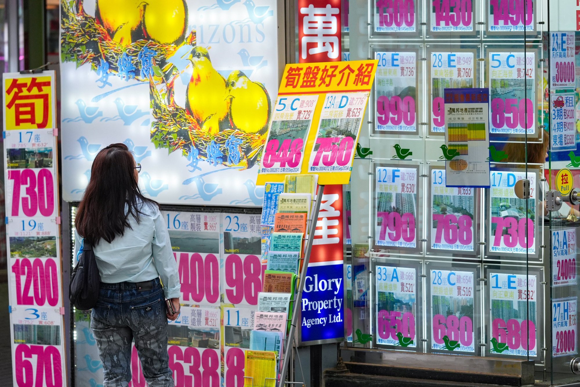 A woman peruses listings at a property agency near South Horizons in Ap Lei Chau on October 15, 2024. Photo: Eugene Lee