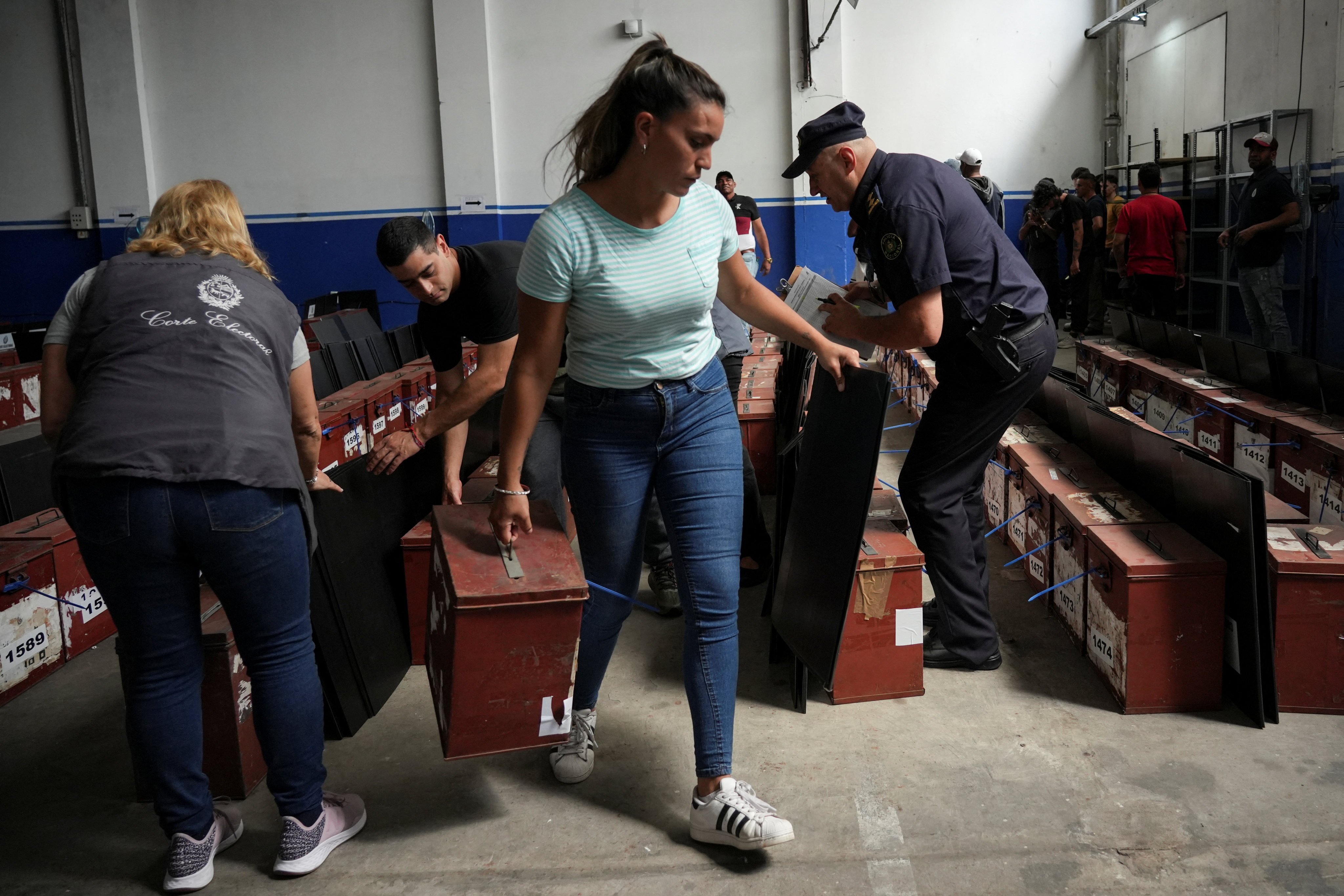 Police and election workers prepare voting materials for Sunday’s presidential run-off election, in Montevideo, Uruguay. Photo: Reuters