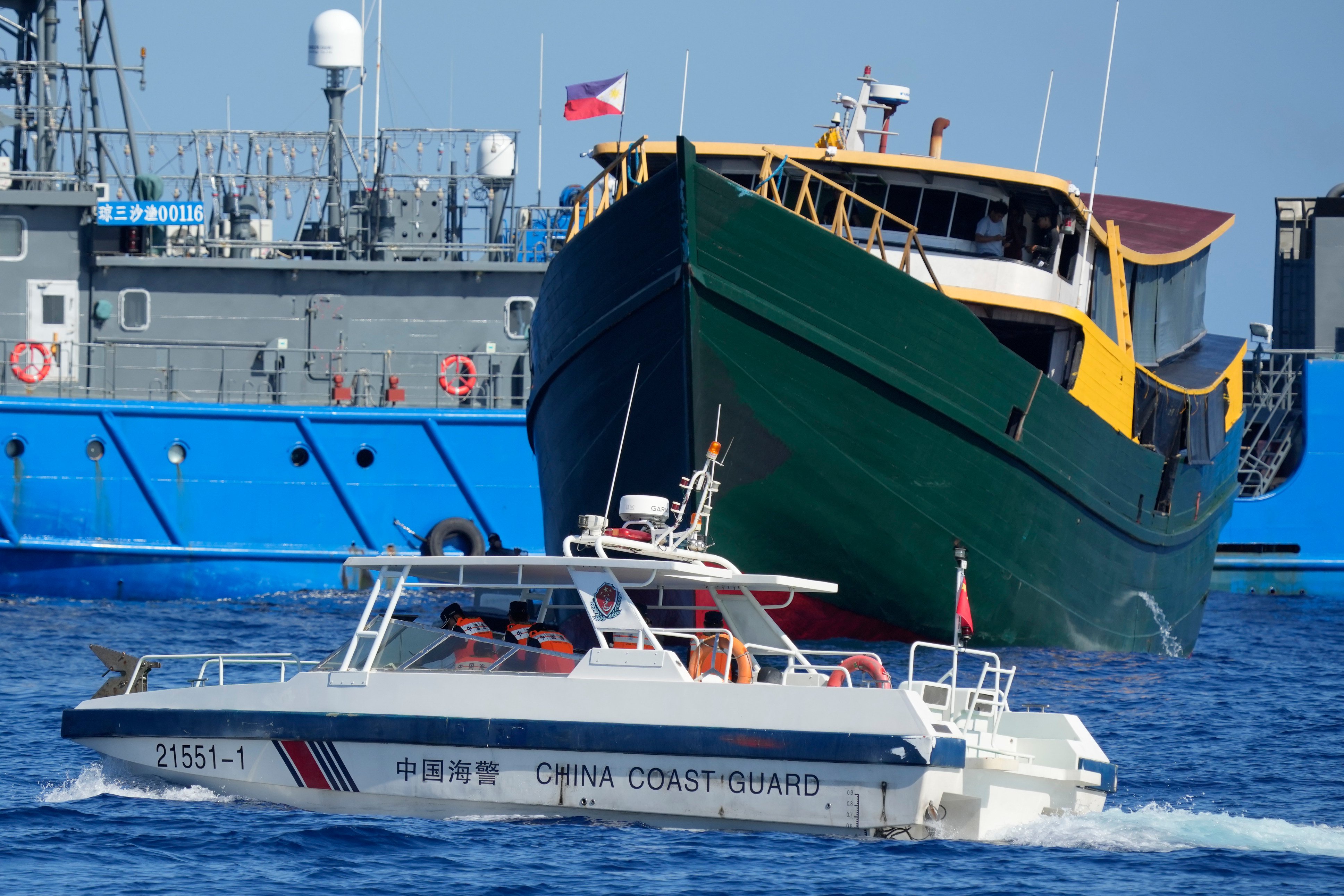 A Philippine resupply vessel (in green) encounters a Chinese coastguard boat near the Second Thomas Shoal, locally known as Ayungin Shoal, in the disputed South China Sea. China has repeatedly impeded Manila’s missions to repair and resupply the BRP Sierra Madre grounded at the shoal. Photo: AP