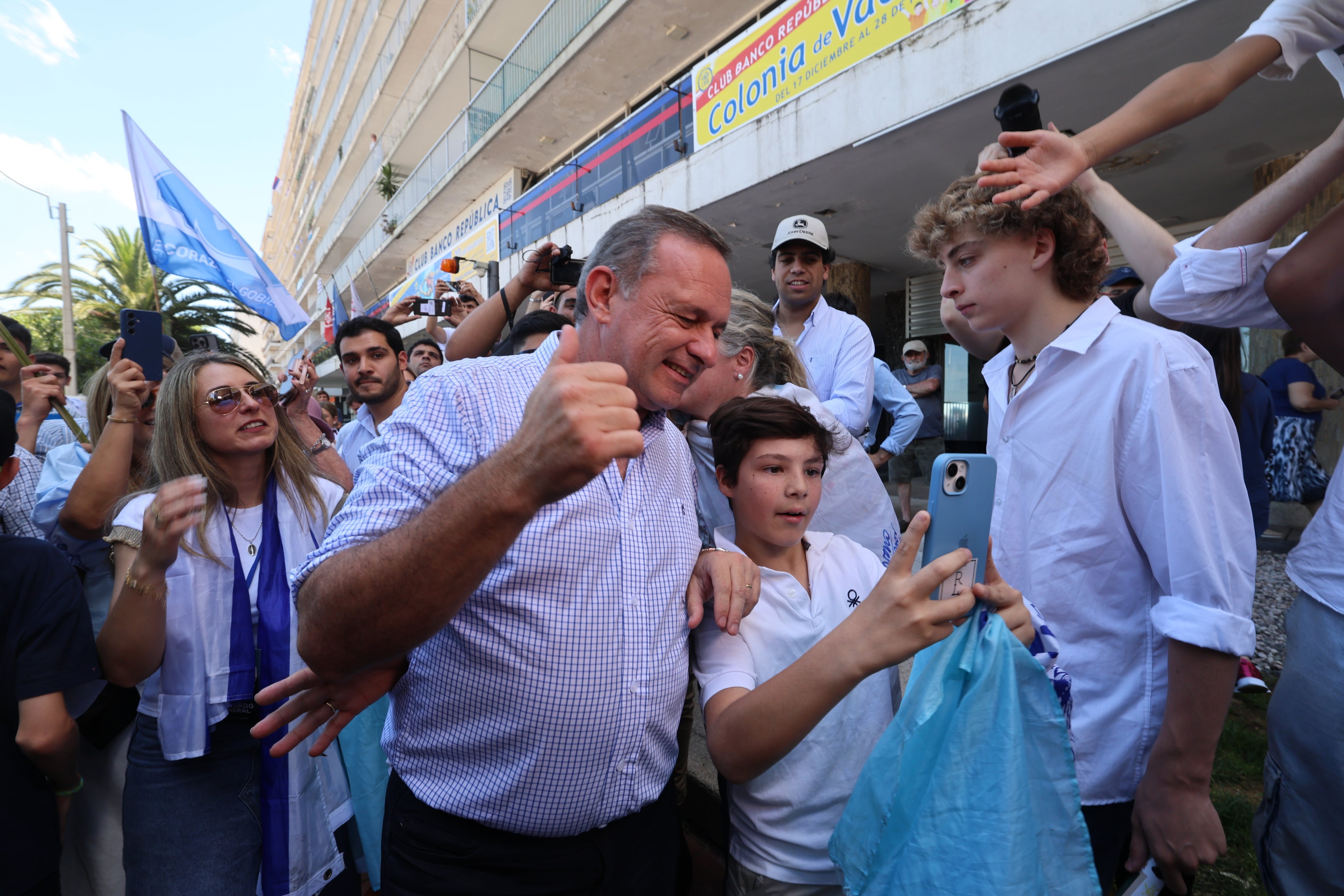 Presidential candidate Alvaro Delgado, centre, takes a photo with a supporter during the second round of the presidential elections, in Montevideo, Uruguay on Sunday. Photo: EPA-EFE