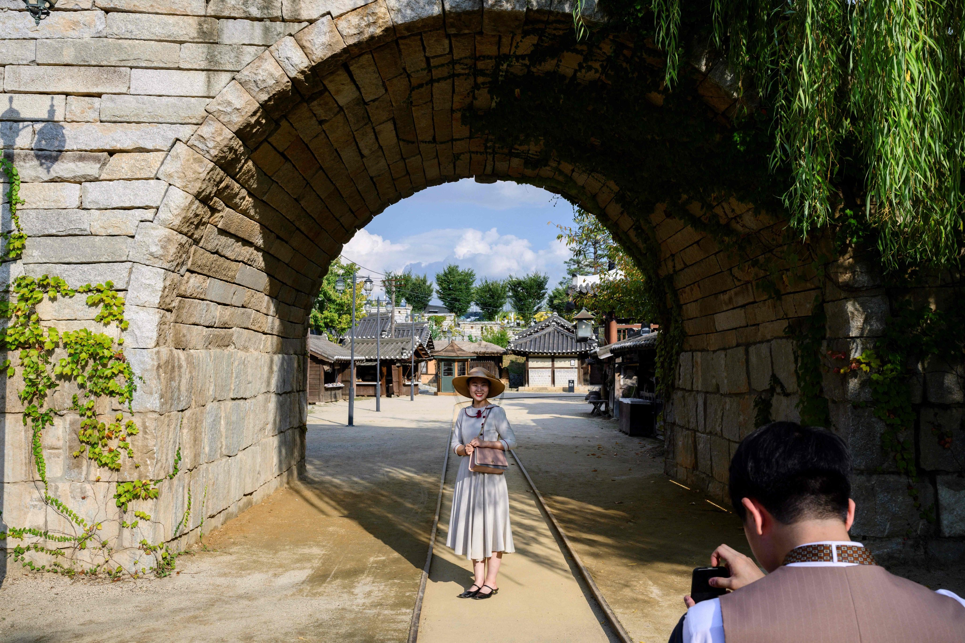 Visitors take photos at a railway arch featured in the K-drama series Mr Sunshine, at Sunshine Studio in Nonsan, South Korea. Photo: AFP