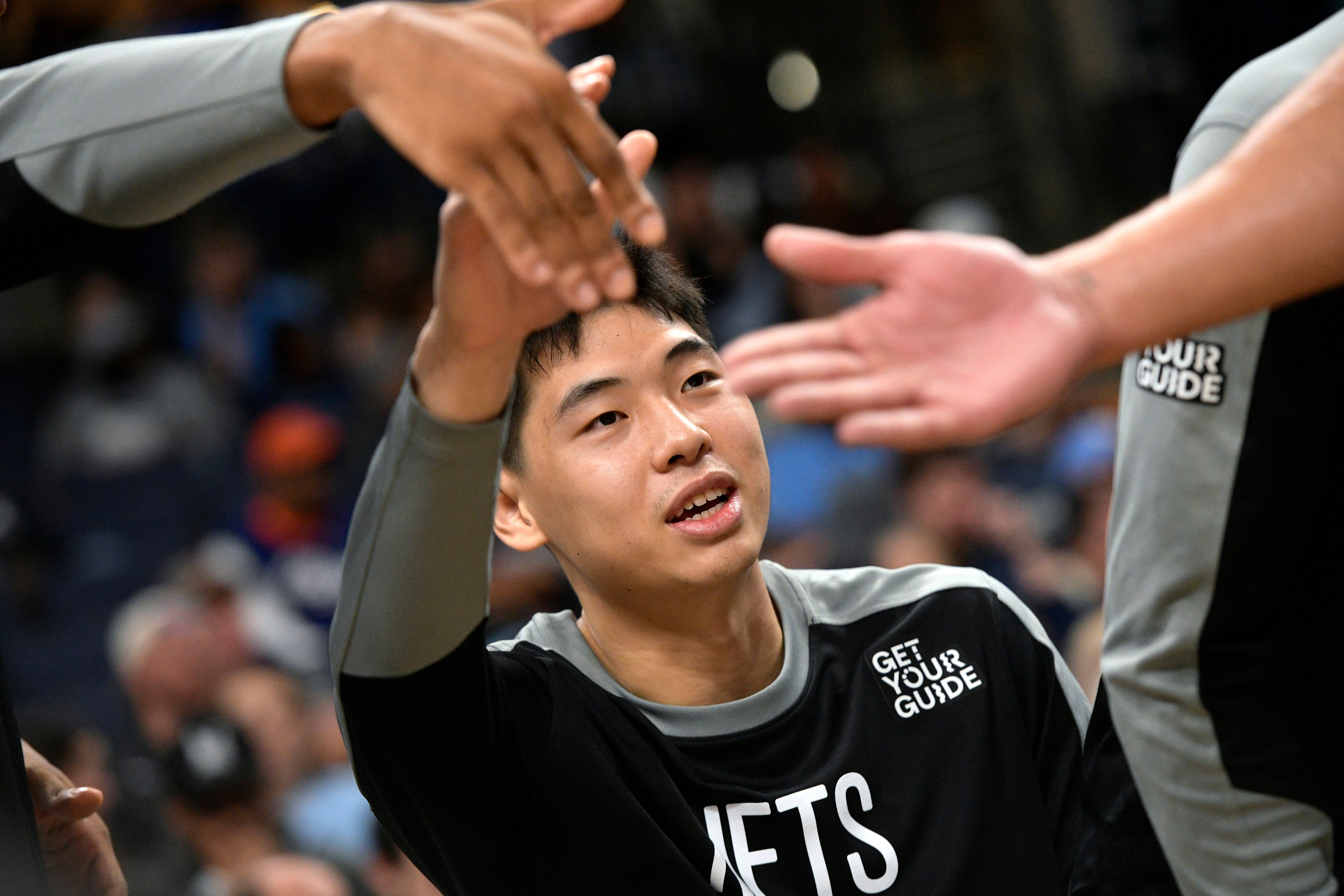 Brooklyn Nets guard Cui Yongxi high-fives teammates in the first half of an NBA game against the Memphis Grizzlies in October. Photo: AP