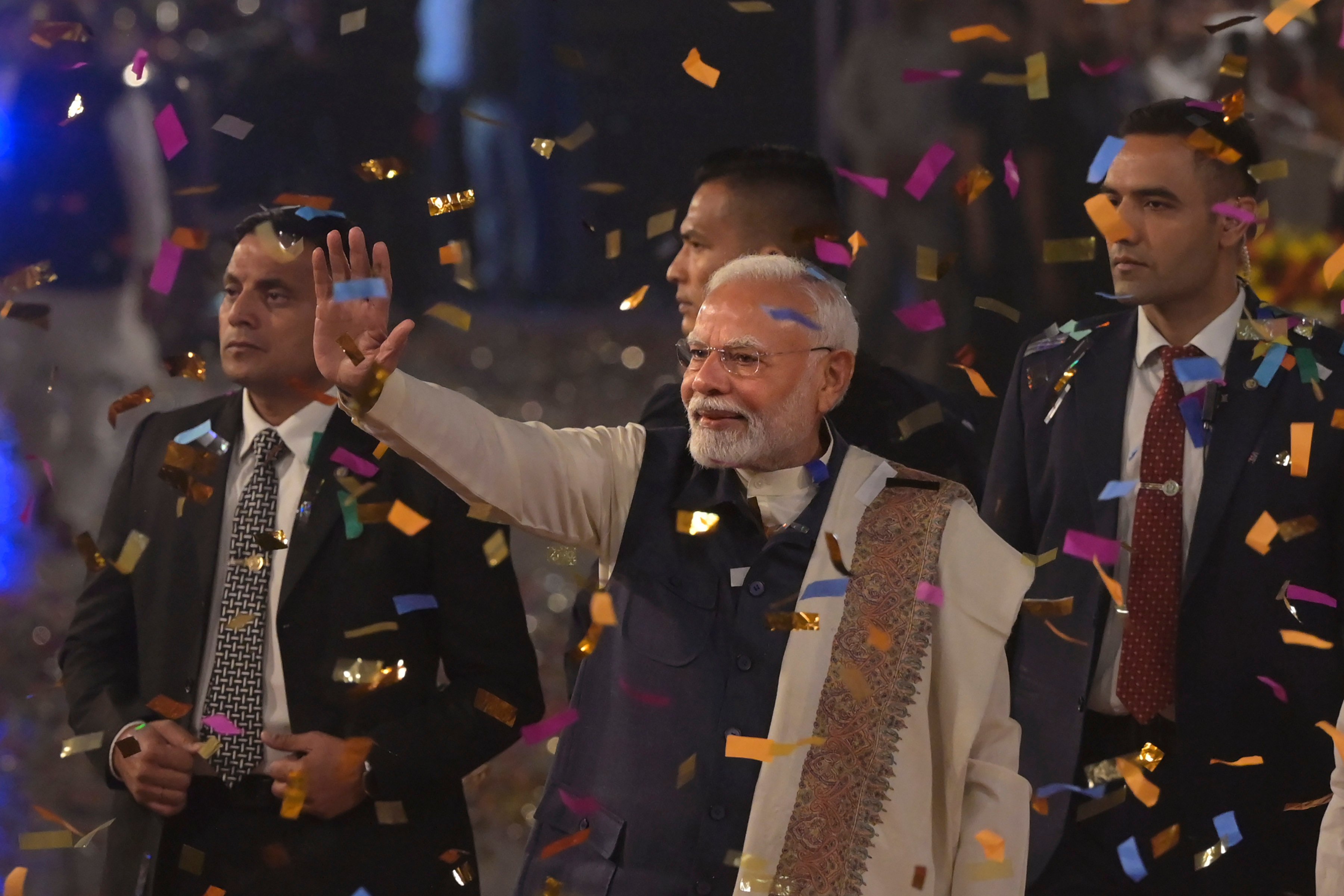 Bharatiya Janata Party supporters shower confetti and flower petals as Indian prime minister Narendra Modi, centre, arrives to address them at the party headquarters after winning the state elections in politically significant Indian state of Maharashtra, in New Delhi on Saturday. Photo: AP