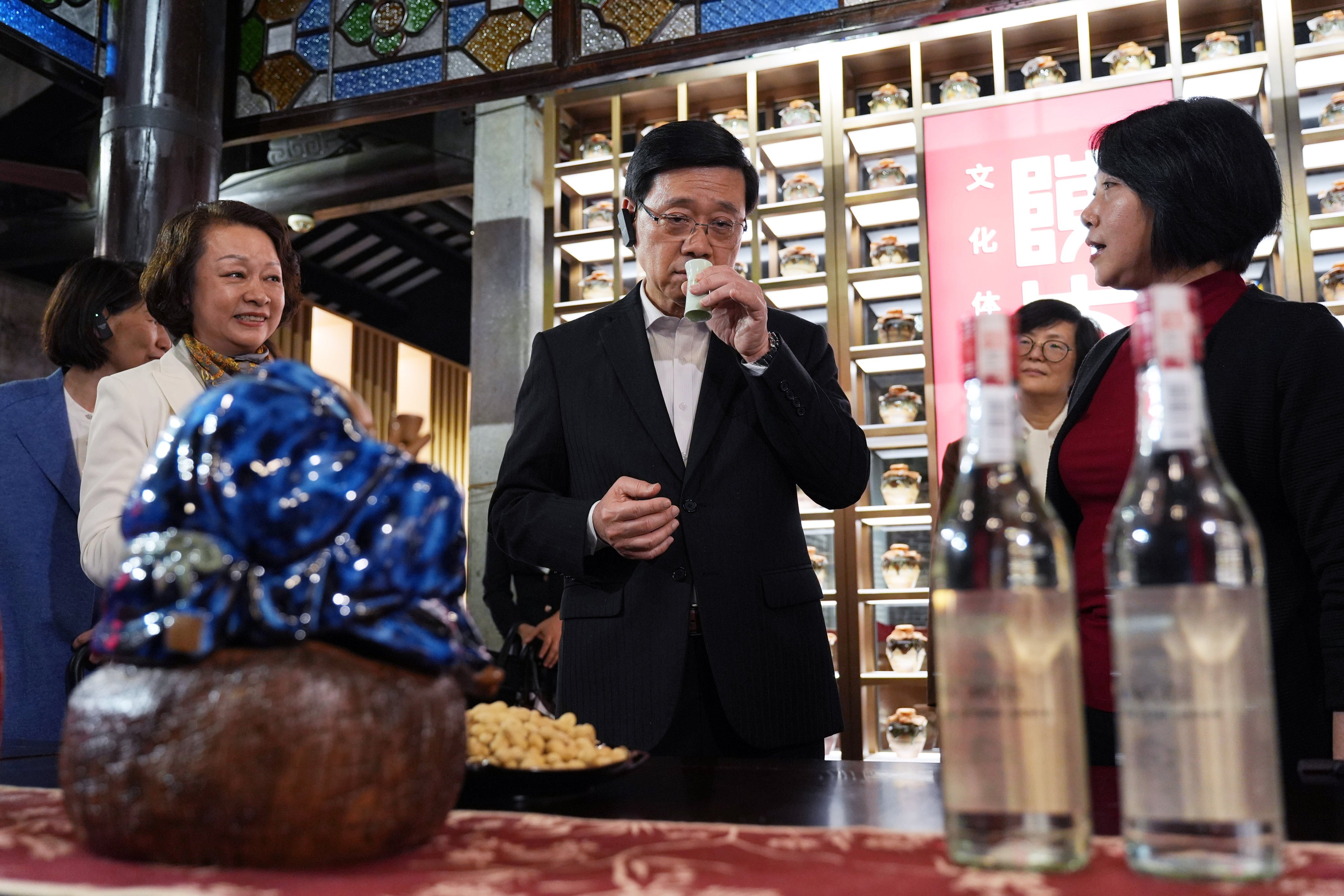 City leader John Lee examines wine products at Lingnan Tiandi, a revamped cultural and heritage site. Photo: Eugene Lee