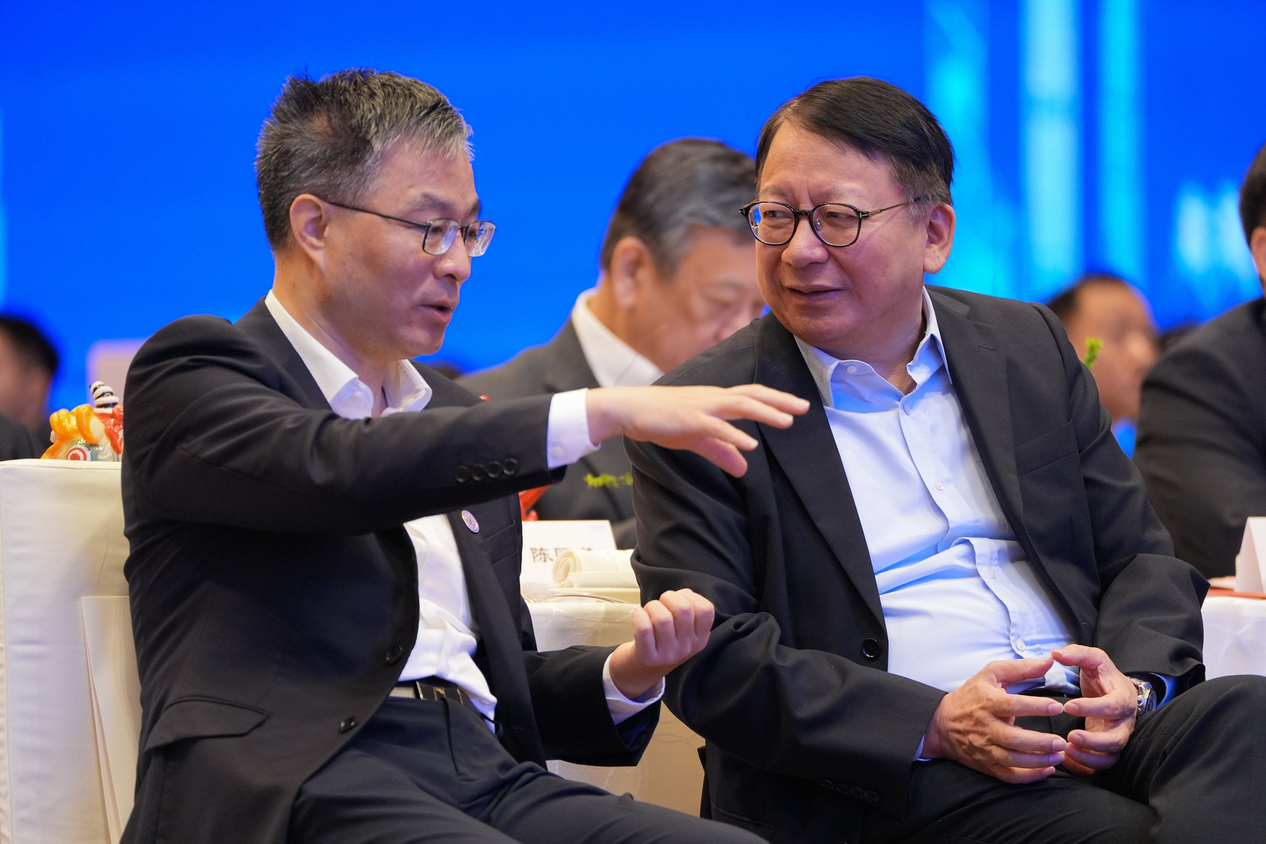 Chief Secretary Eric Chan (right) chats with Tang Yifeng, secretary of the CPC Foshan Committee, during a visit to the mainland. Photo: Eugene Lee