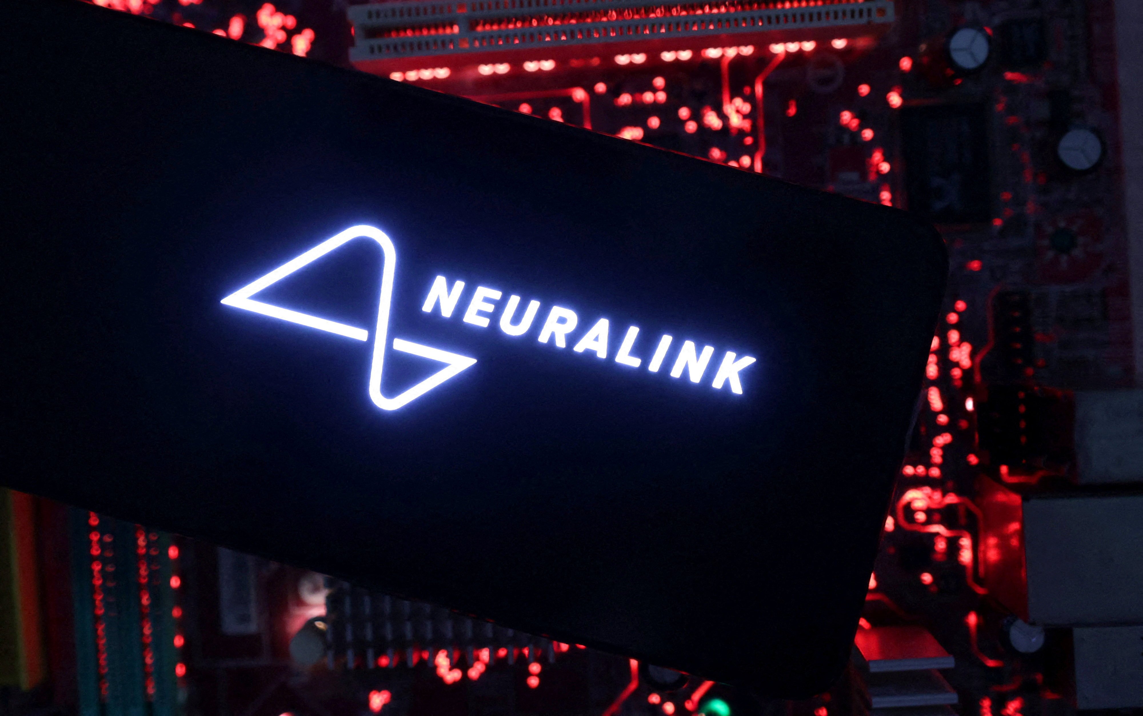 A smartphone with a Neuralink logo displayed is placed on a computer motherboard in this illustration taken May 15, 2024. Photo: Reuters