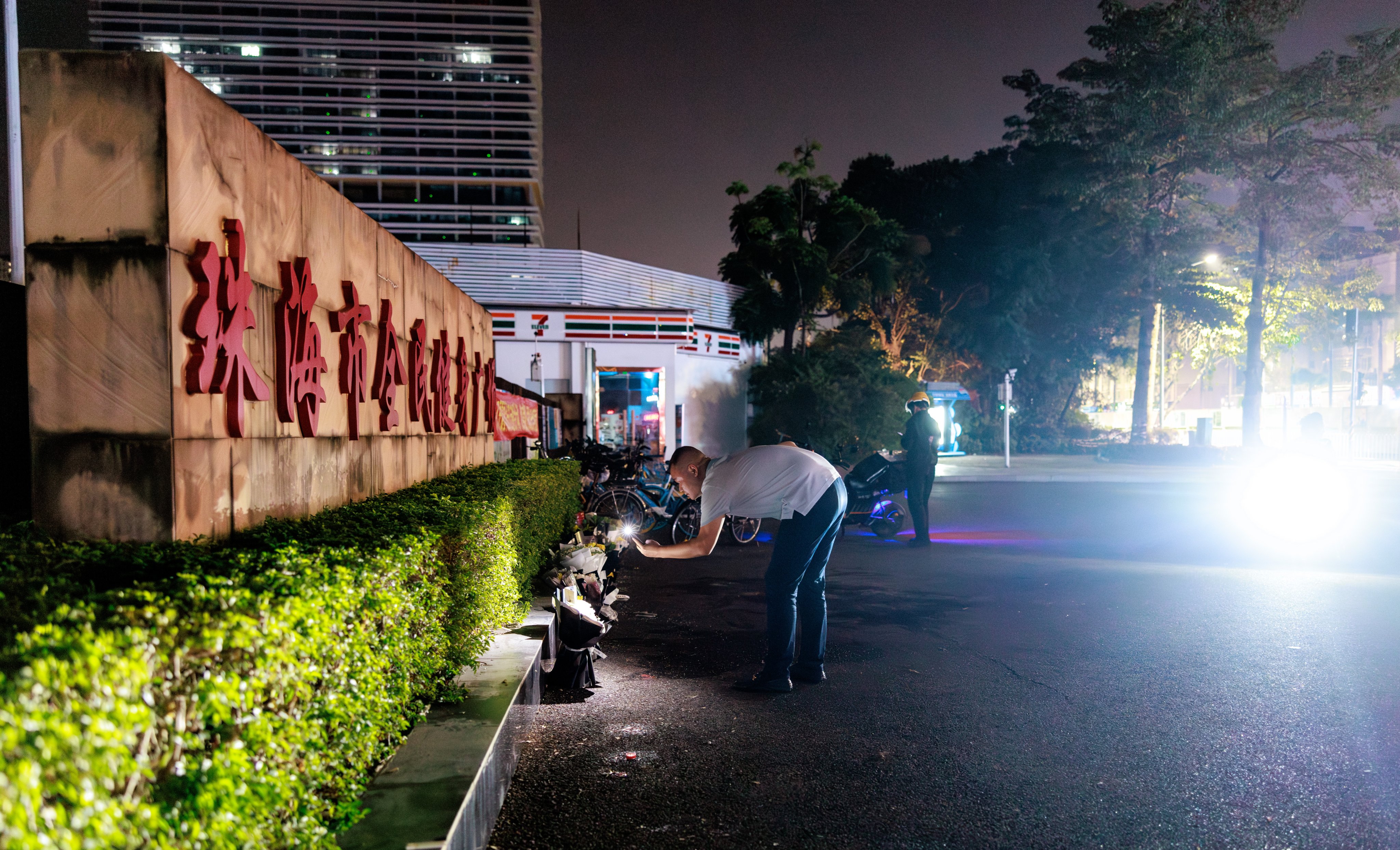 Residents places tributes to the dead outside the stadium in Zhuhai where 35 people were killed by an SUV. Photo: EPA-EFE