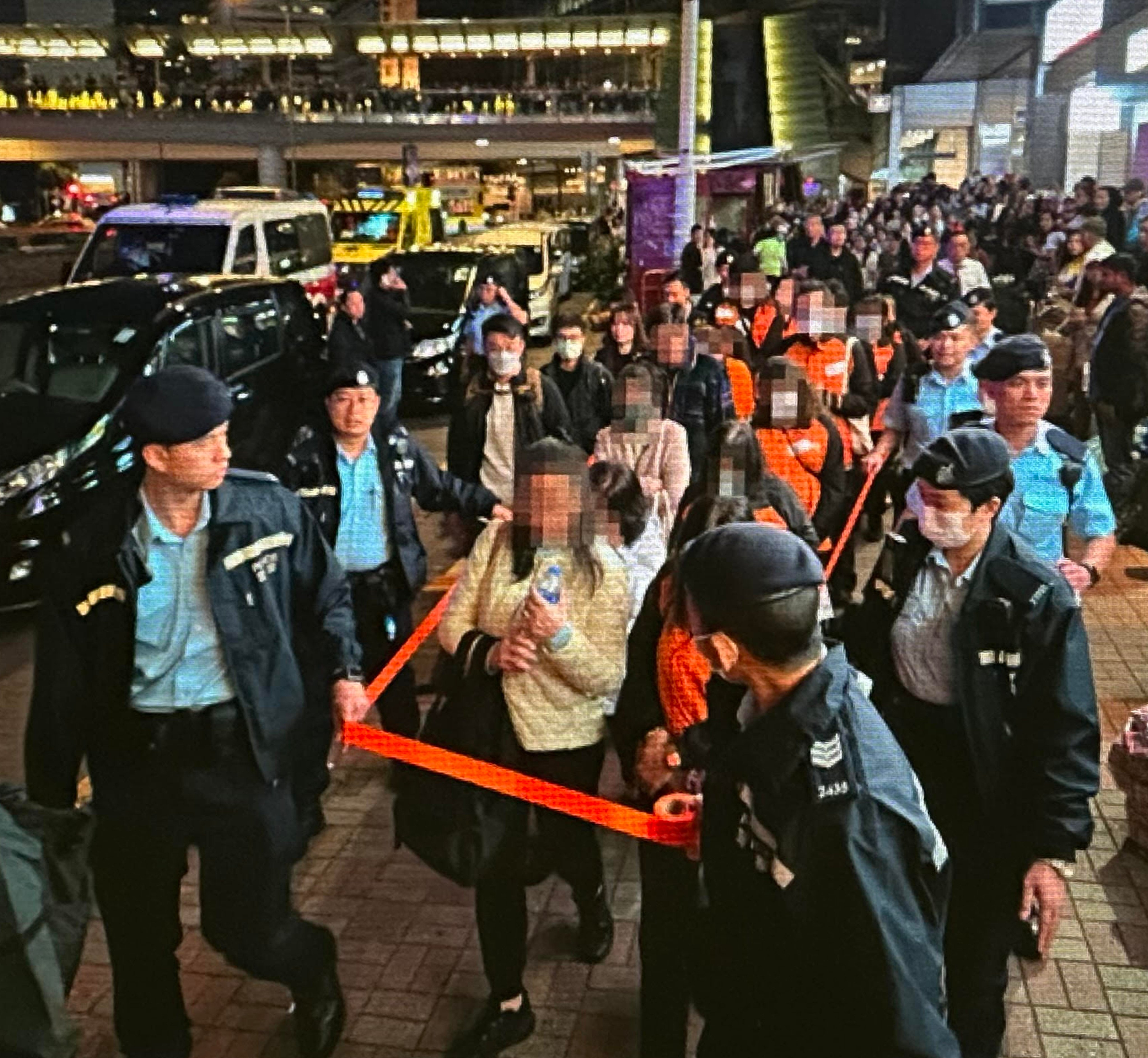 Hong Kong police escorting suspects from a building in Central. Photo: Handout