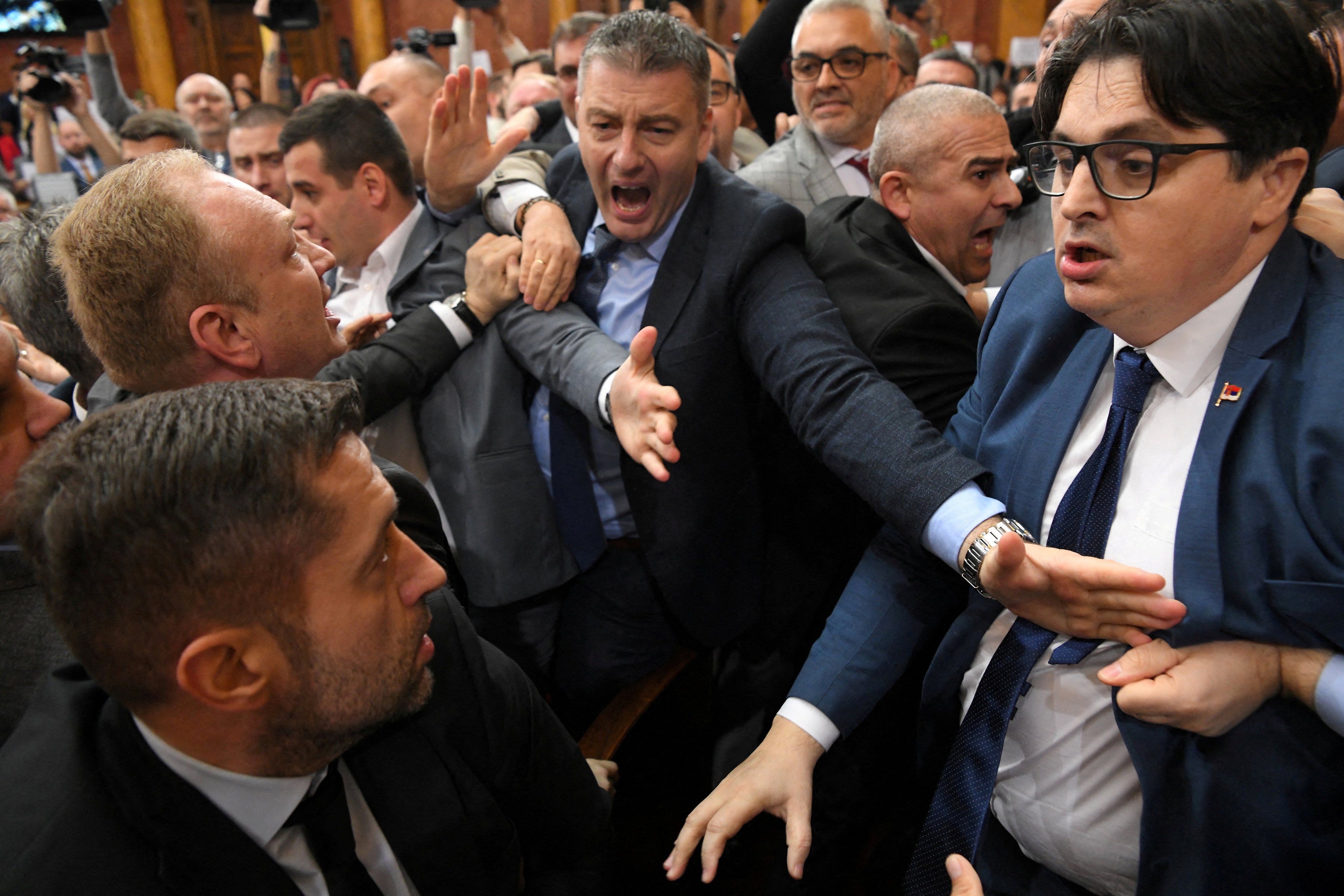 Opposition and the ruling coalition deputies brawl in the Serbian parliament hall in Belgrade, Serbia on Monday. Photo: Reuters