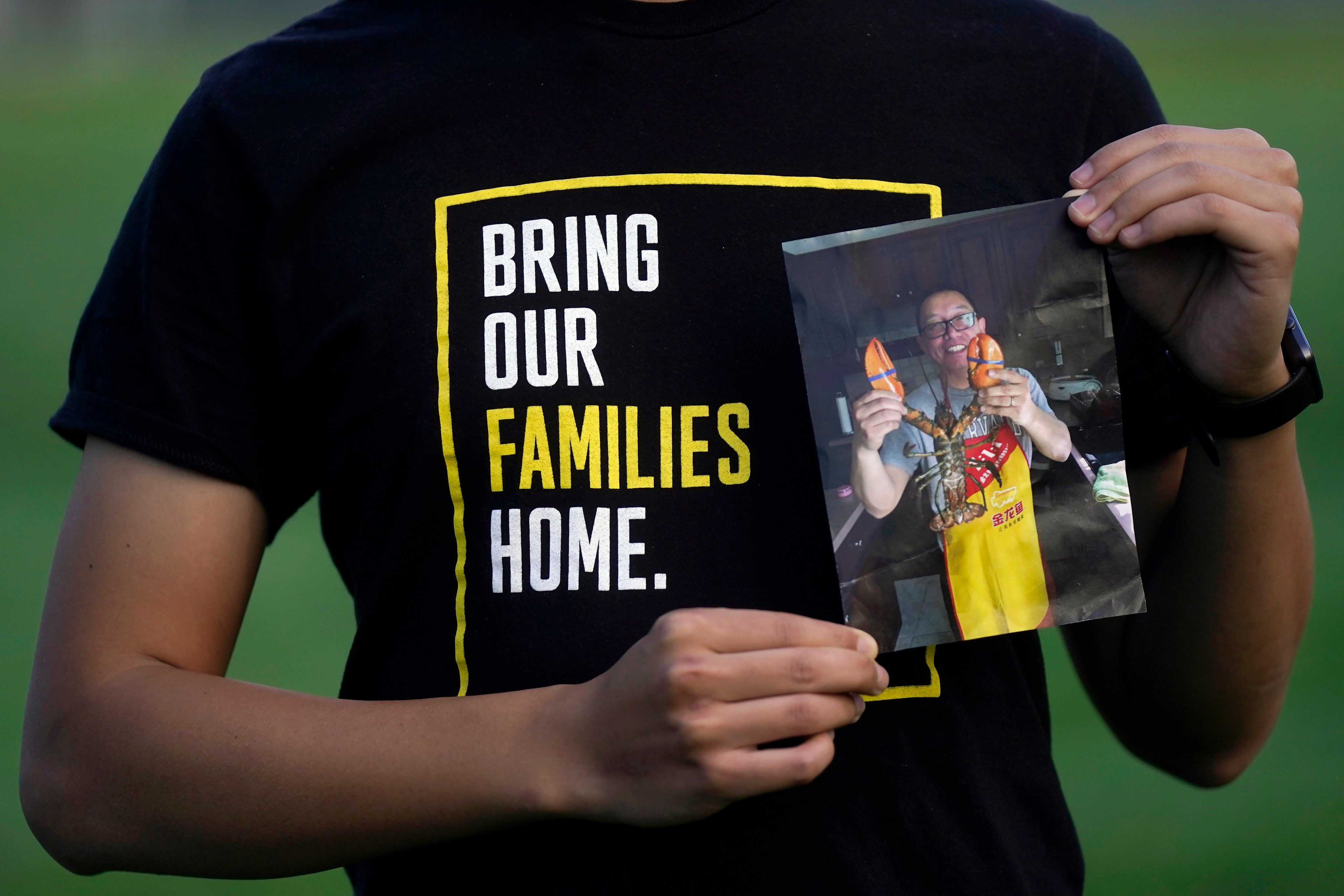 Harrison Li holds a photo of his father, Kai Li, who is being released after years in a Chinese jail. Photo: AP