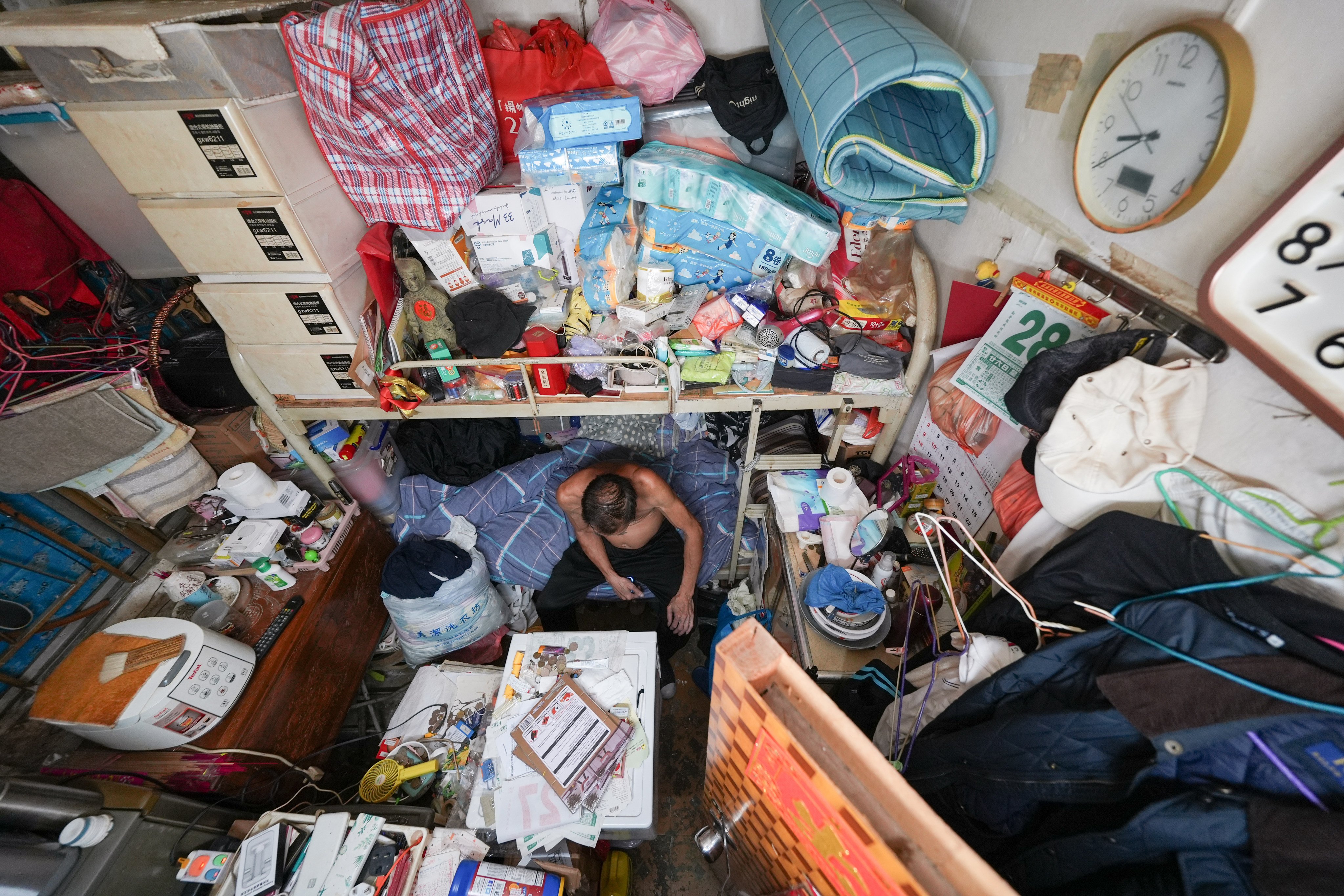 A tenant of a 60 sq ft subdivided flat with no individual toilet in Sham Shui Po. Photo: Eugene Lee