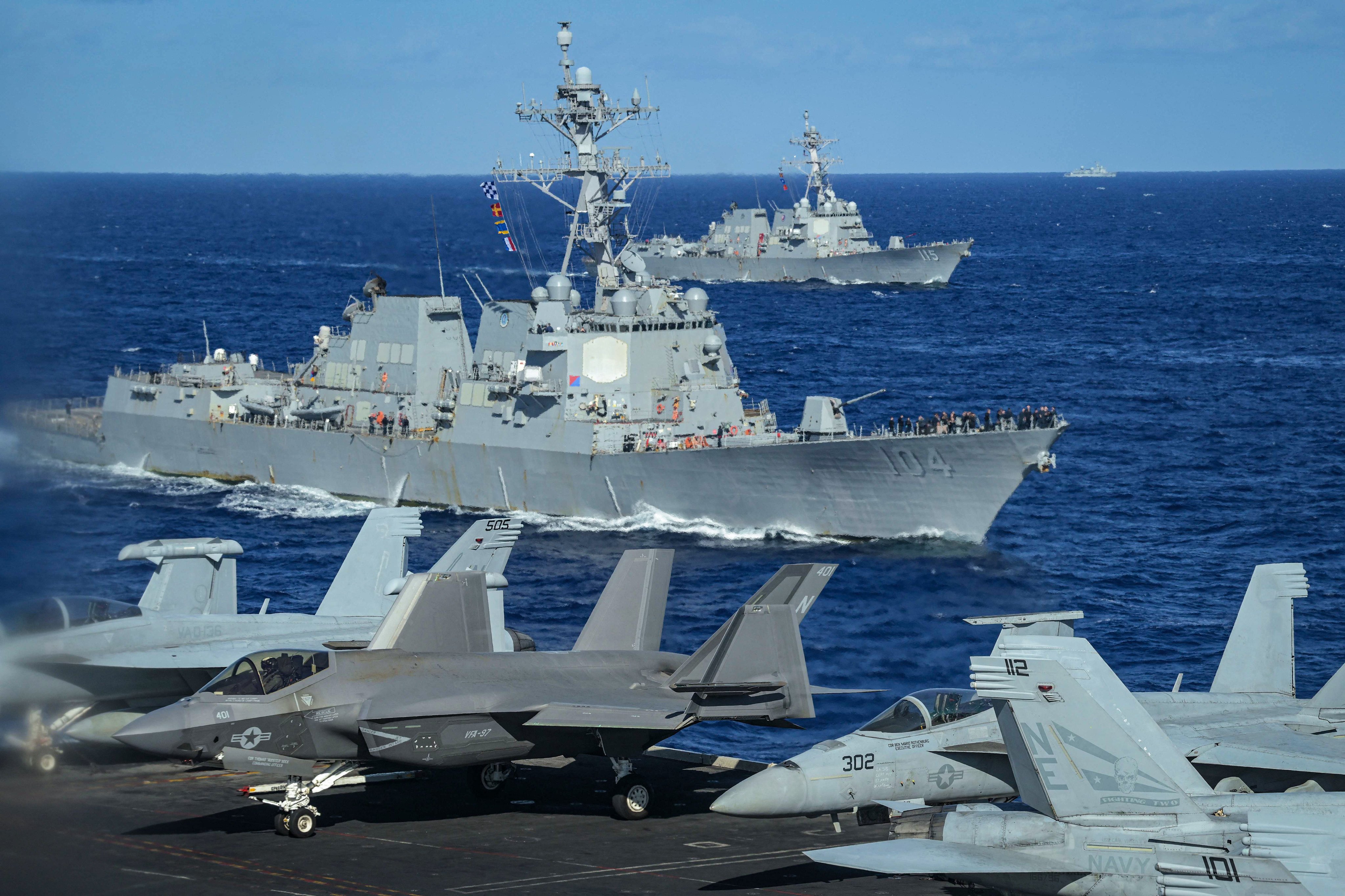 A Chinese military vessel  keeps watch from afar as US warships take part in a maritime exercise with Japan in the Philippine Sea. Photo: AFP