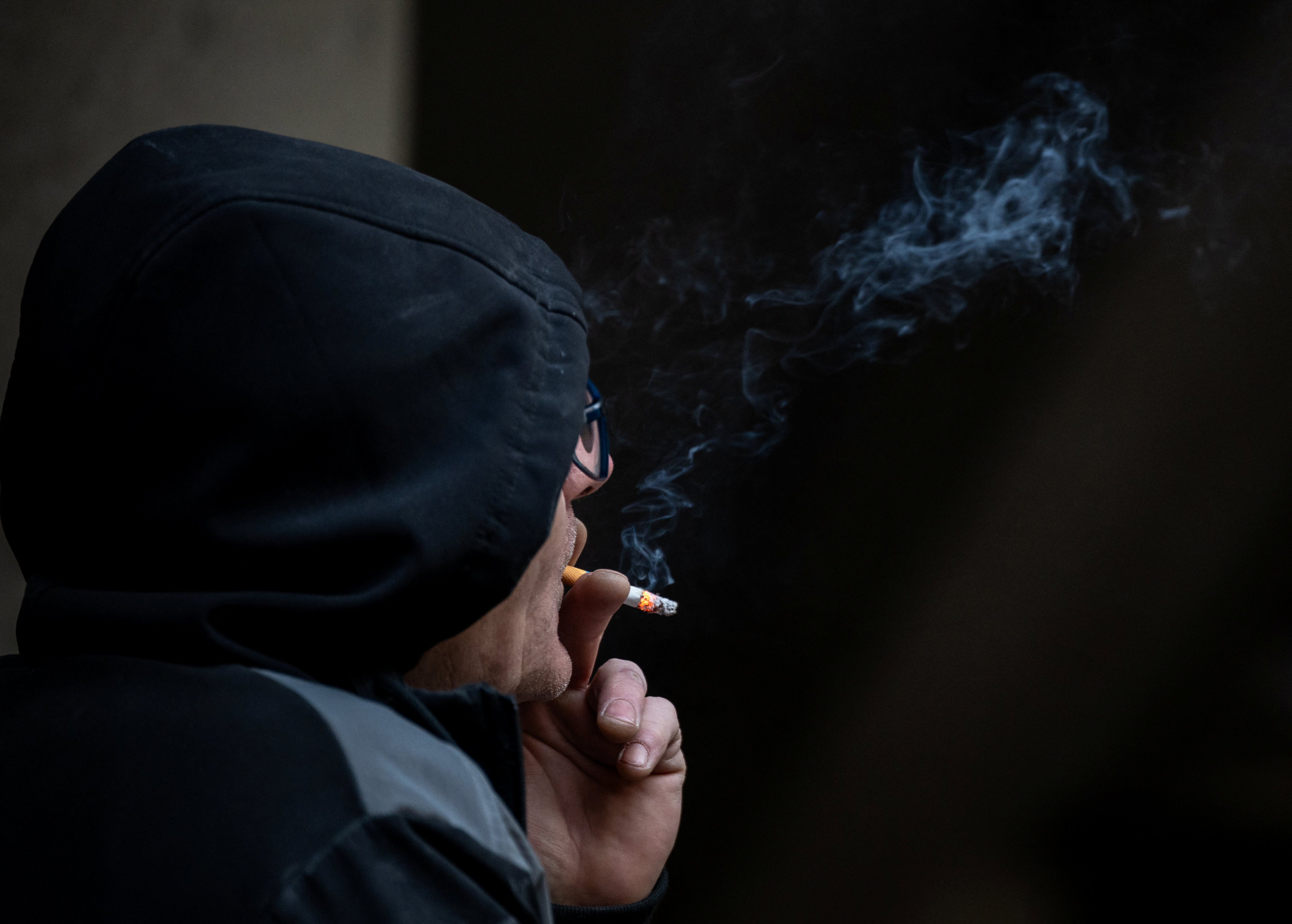 A man smokes a cigarette in London on Tuesday. Photo: Reuters