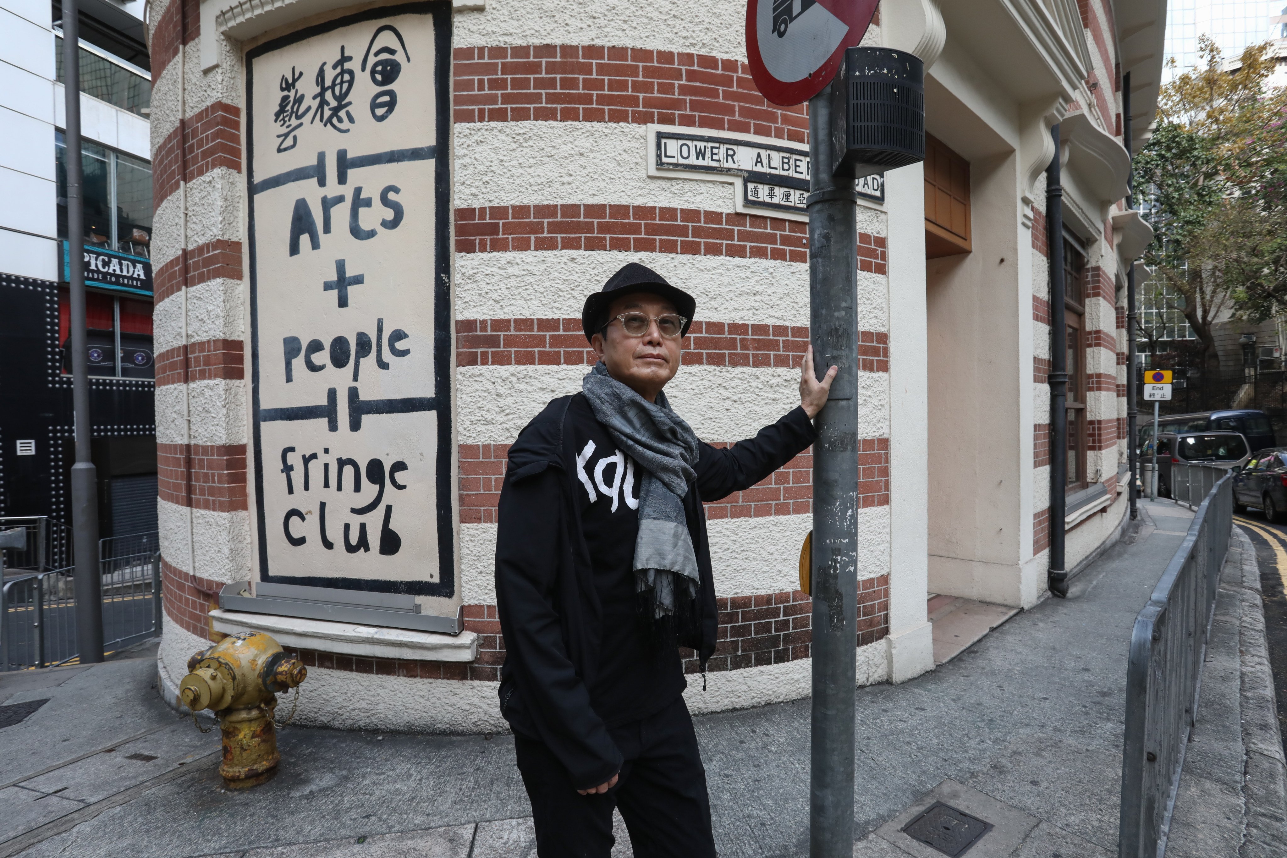 Benny Chia Chun-heng, founder of the Fringe Club in Hong Kong, poses outside the building he turned into a cultural hub. Photo: Jonathan Wong