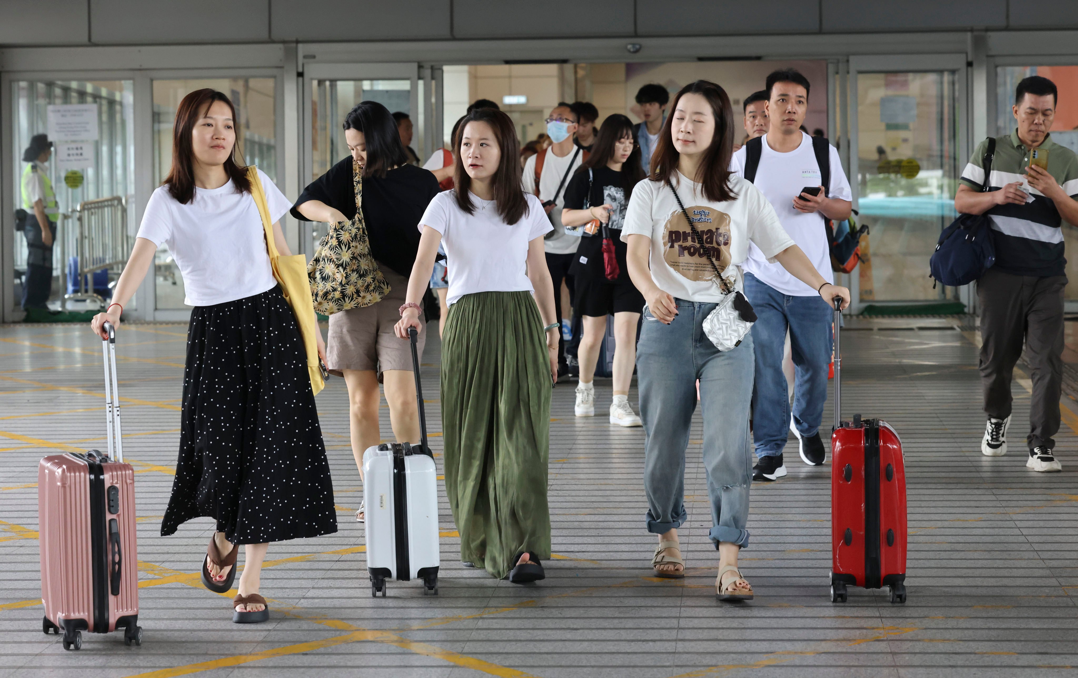 Travellers arrive from mainland China via the Shenzhen Bay border on the first day of the Labour Day holiday week. Photo: Dickson Lee