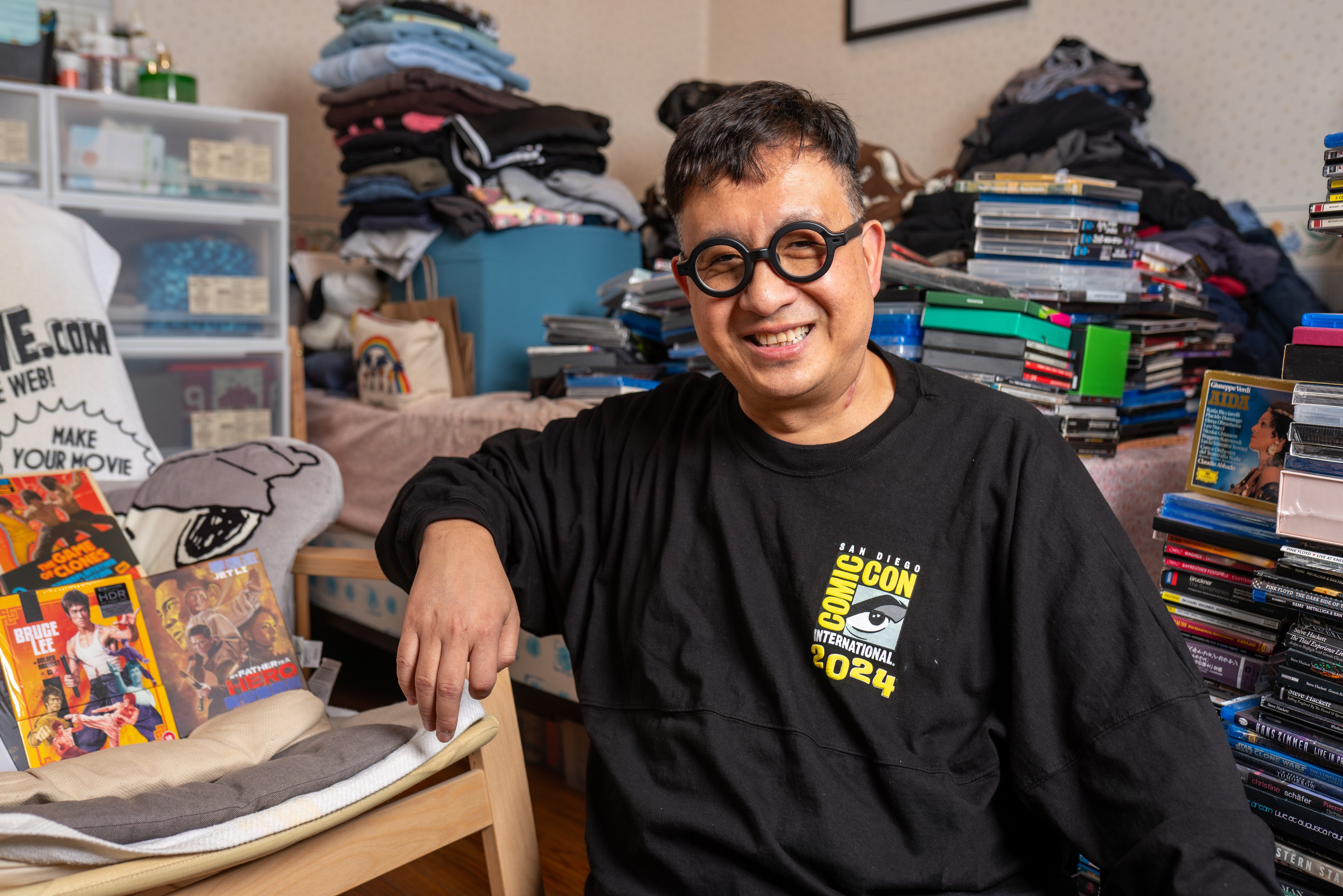 Frank Djeng poses for a photo with his movie collections at his home at Oakland, California, US. Photo: Claire S Burke