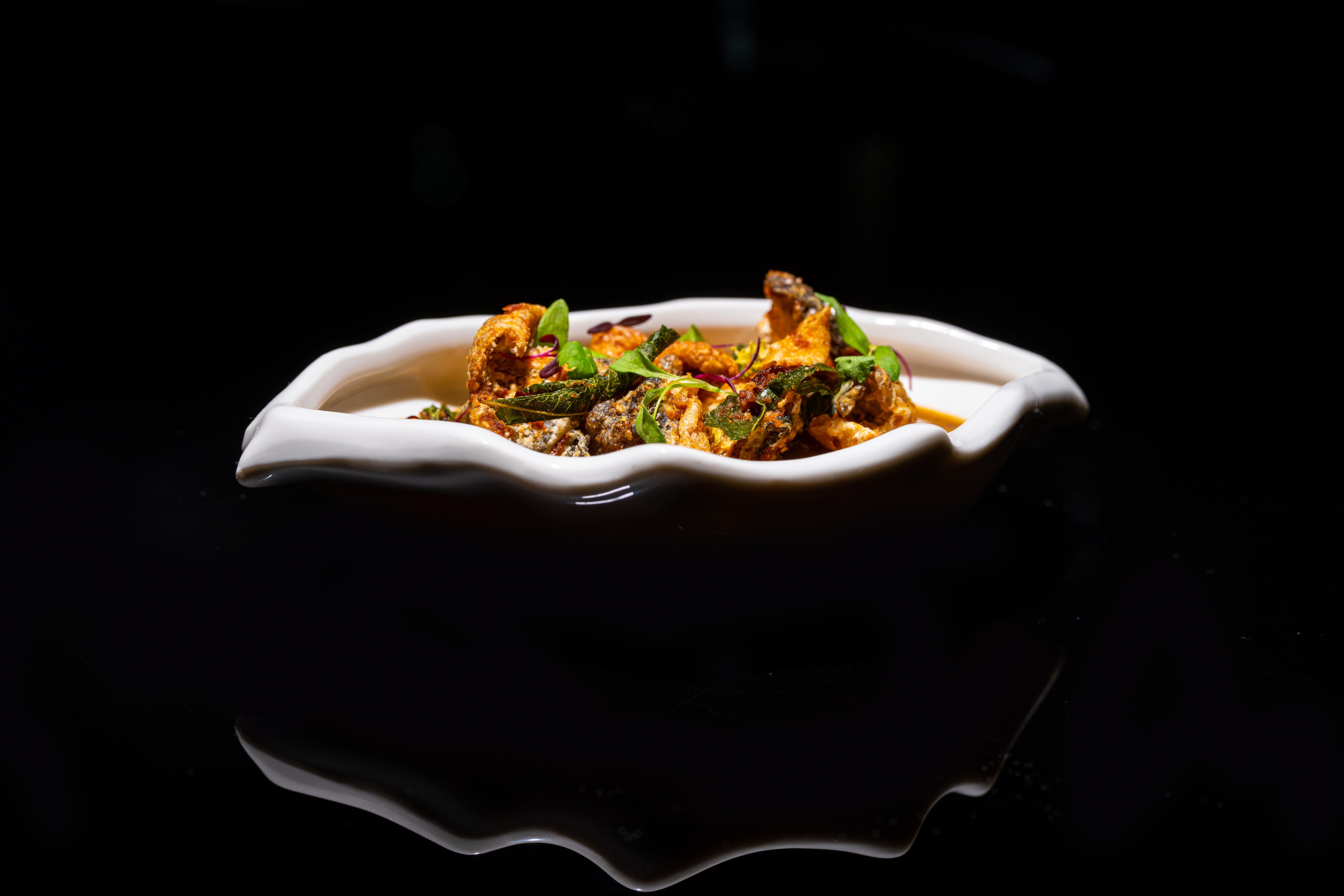 Chef Edward Coon’s mud crab au gratin with Madagascar white pepper, salted egg and fish skin crisp at Auor, Hong Kong. Photo: Handout