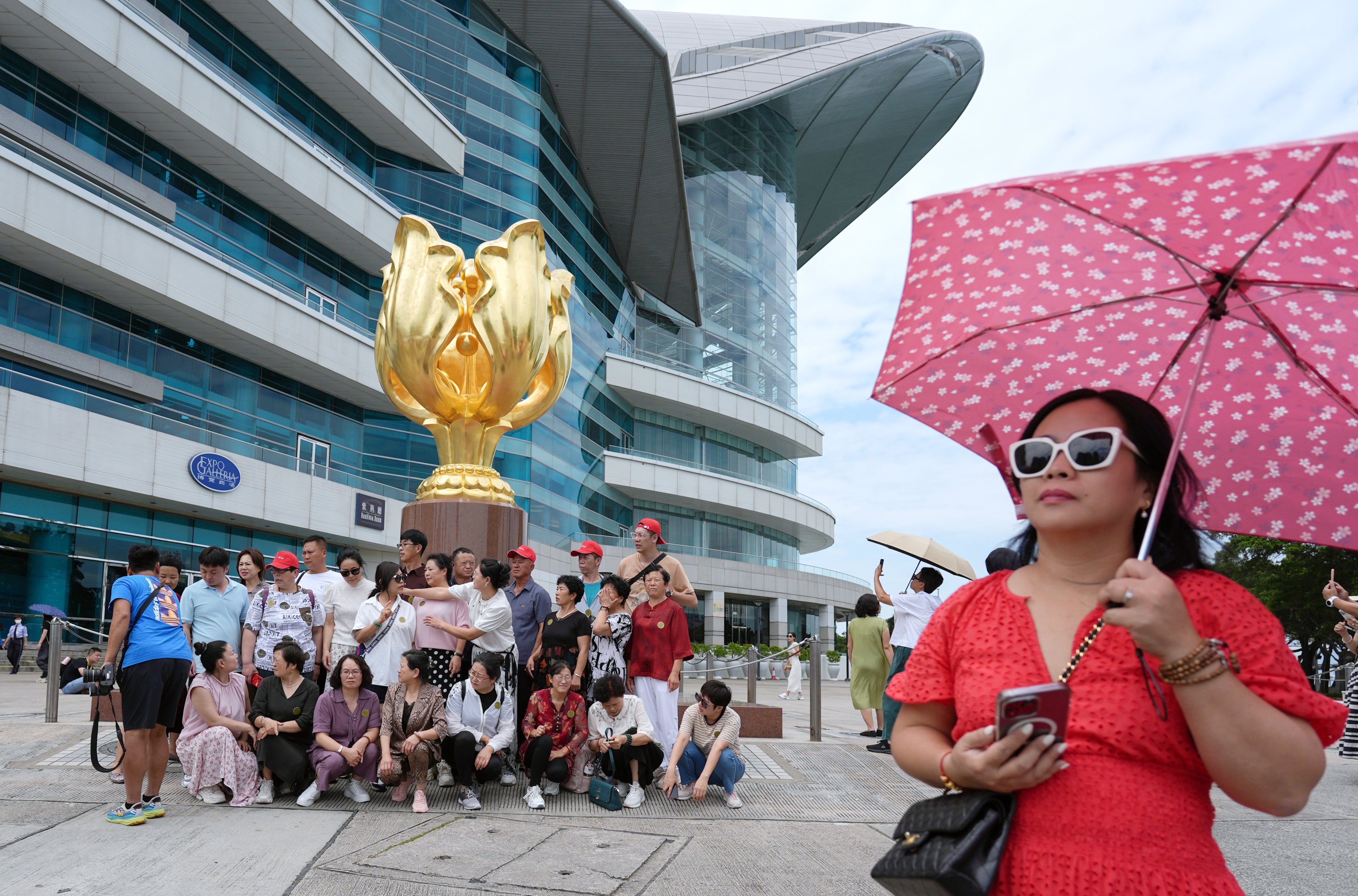 A tour group visits Golden Bauhinia Square in Wan Chai. Photo: Eugene Lee