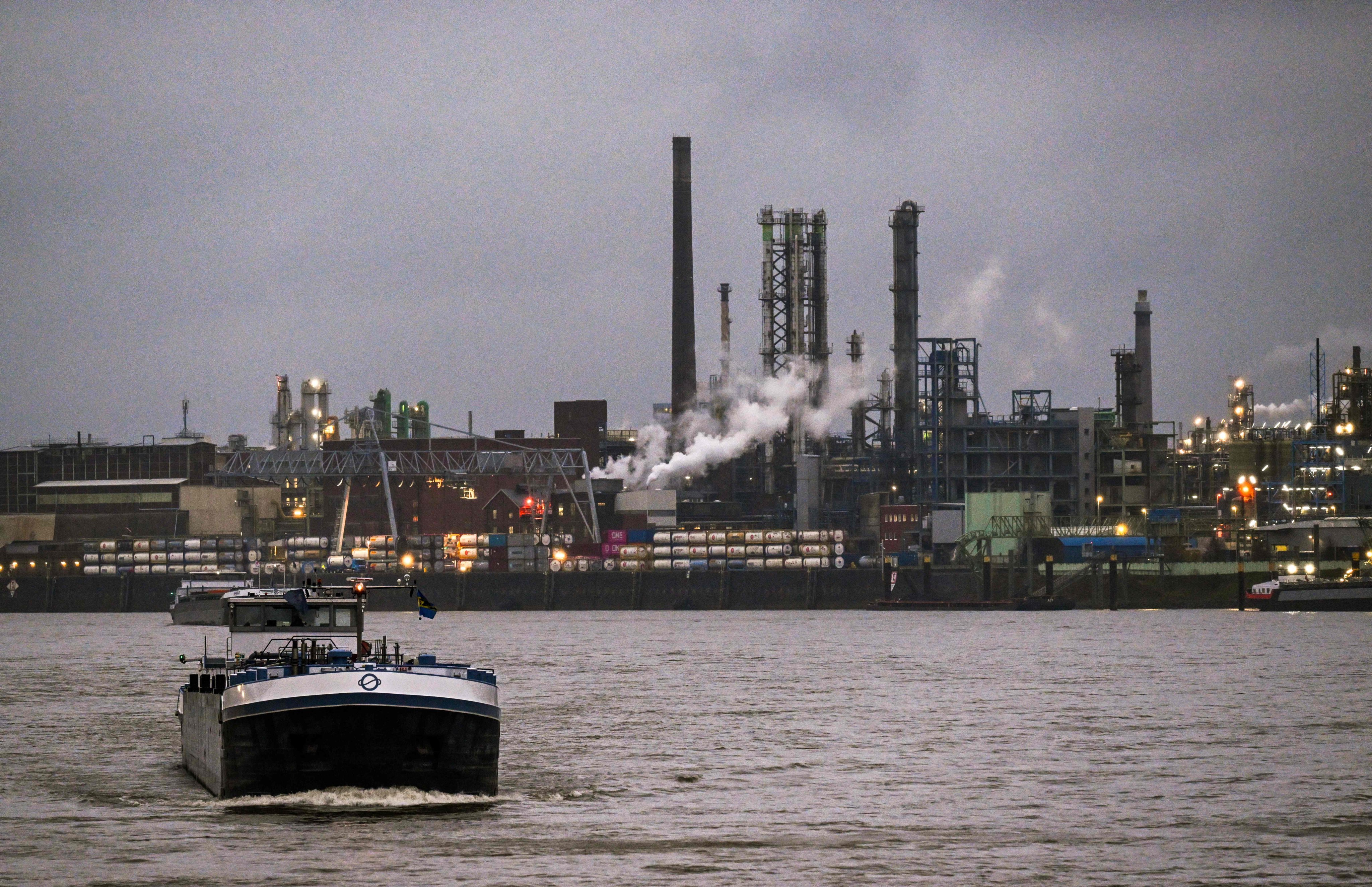 A vessel passes a German chemical and pharmaceutical plant on the banks of the Rhine river in Leverkusen, Germany, on November 25. Photo: AFP