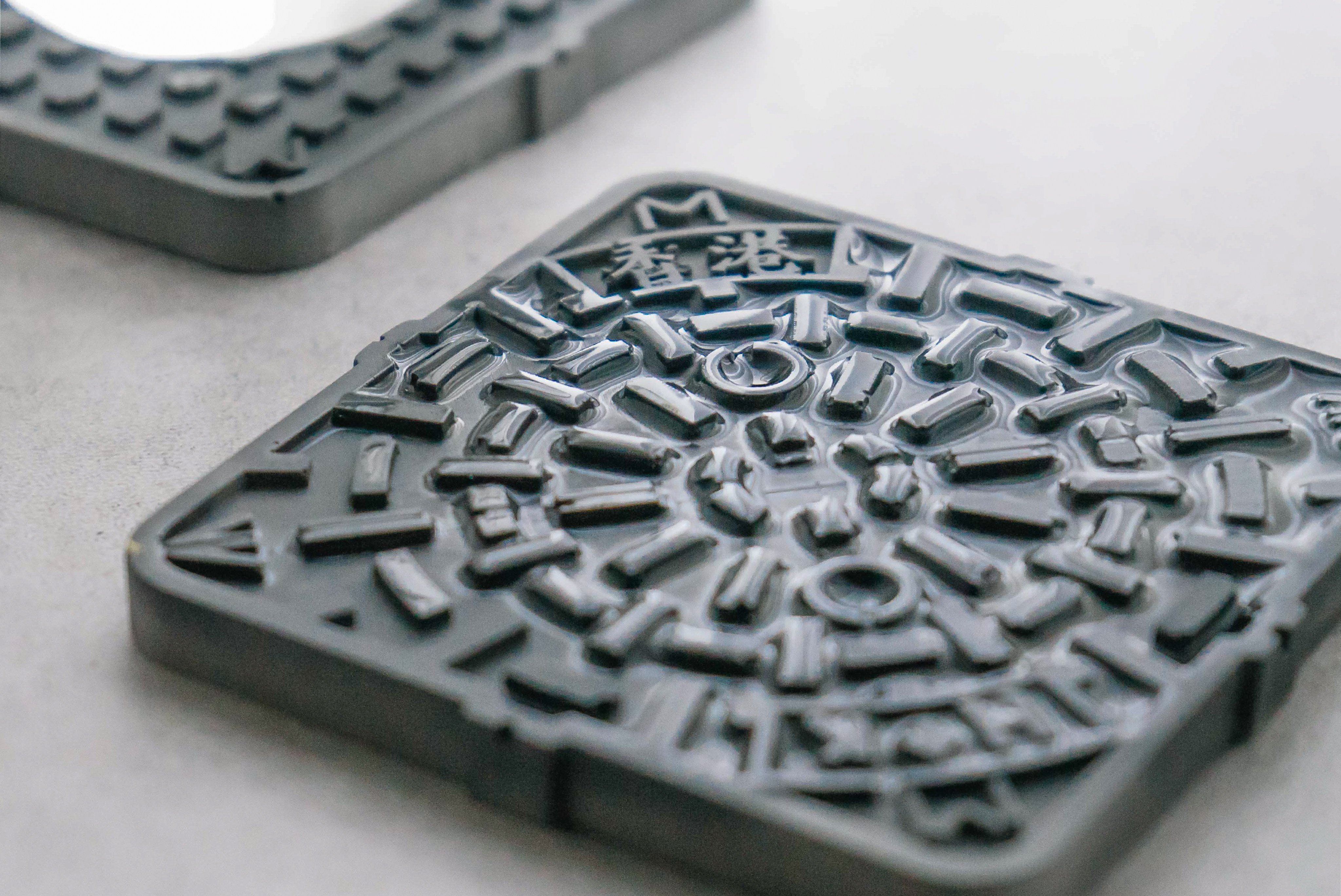 These Hong Kong manhole cover coasters by Concretology are made of diatomite concrete. Photo: Handout