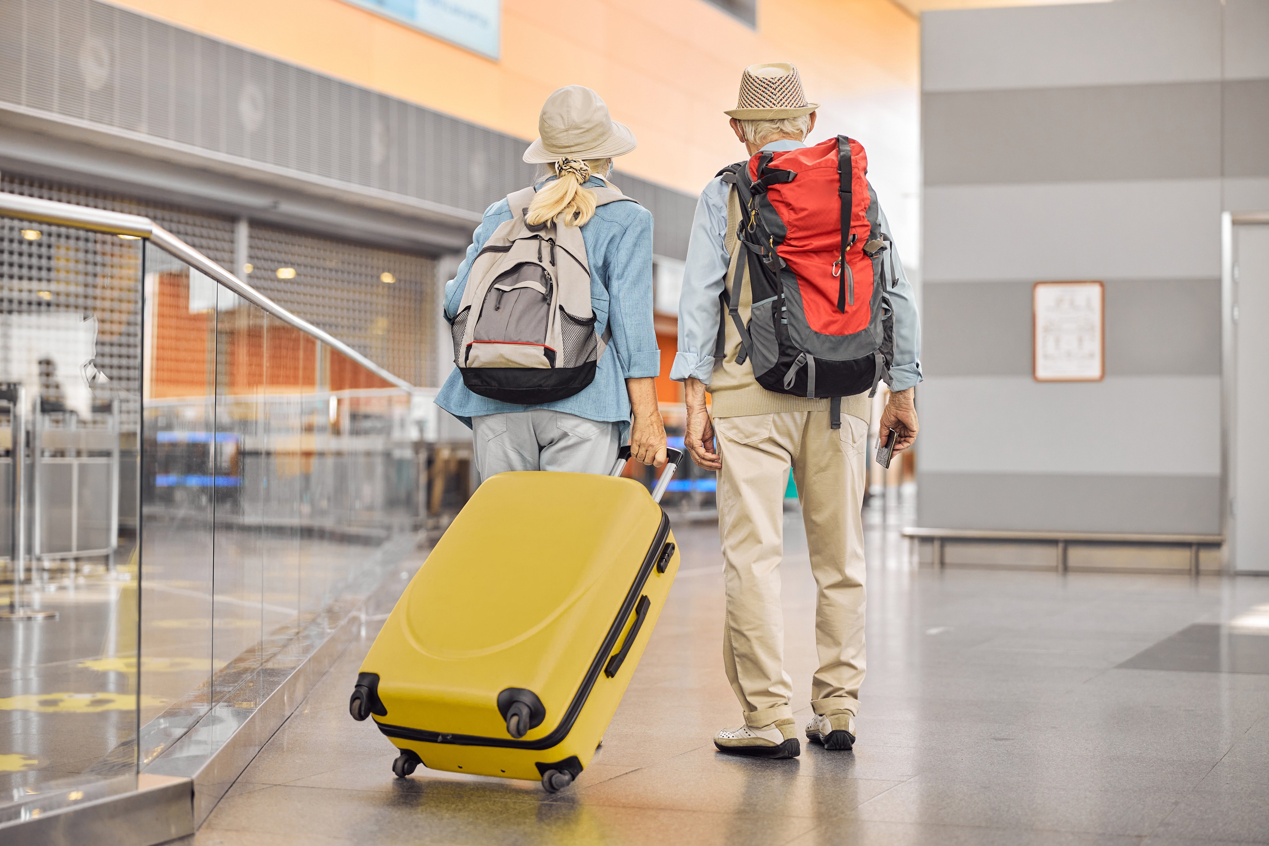 A retired couple at an airport. Being free of work commitments can make travel a breeze for retirees. Photo: Shutterstock