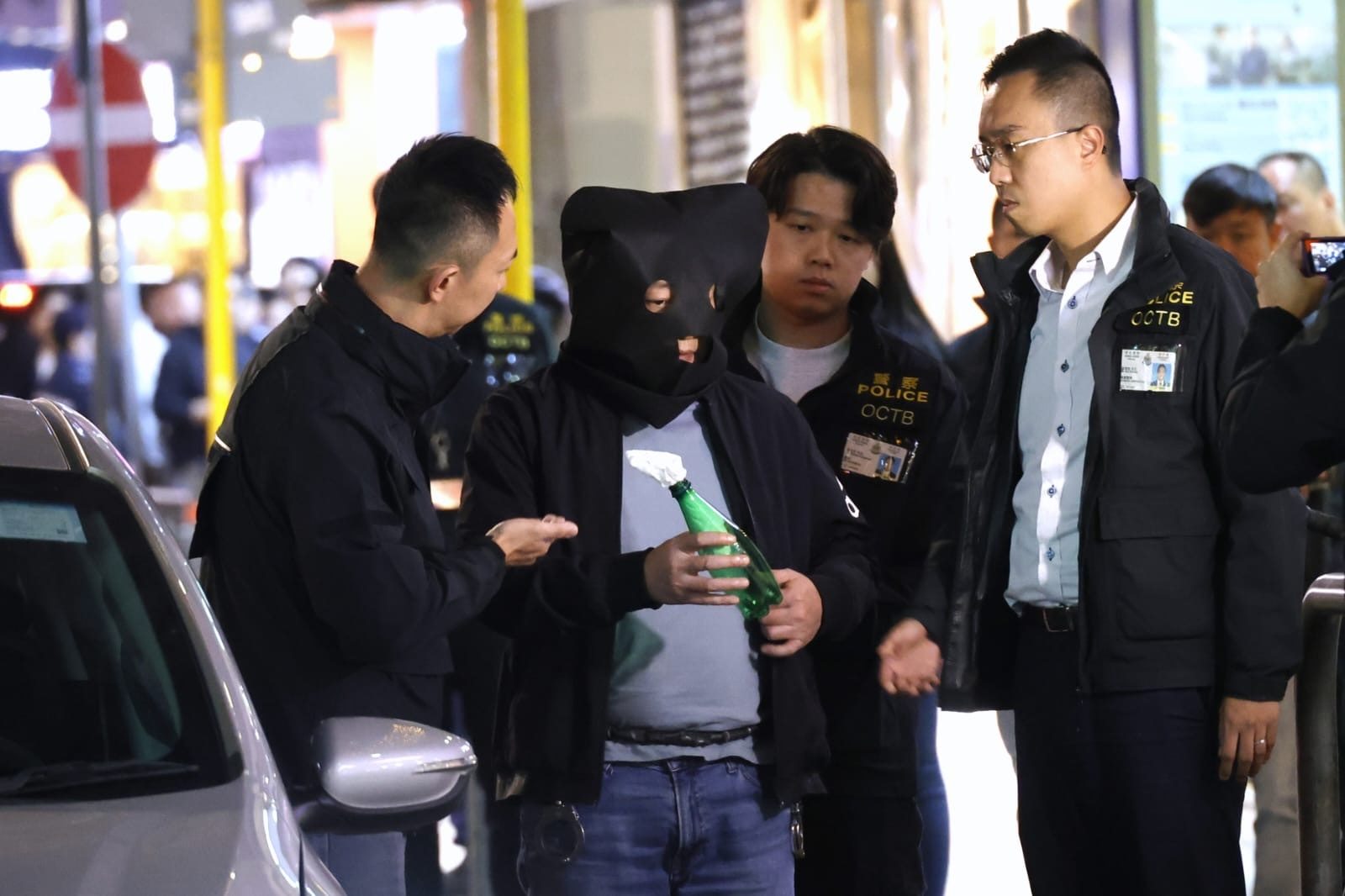 The suspect is taken to Prat Avenue in Tsim Sha Tsui to reconstruct the crime. Photo: Handout