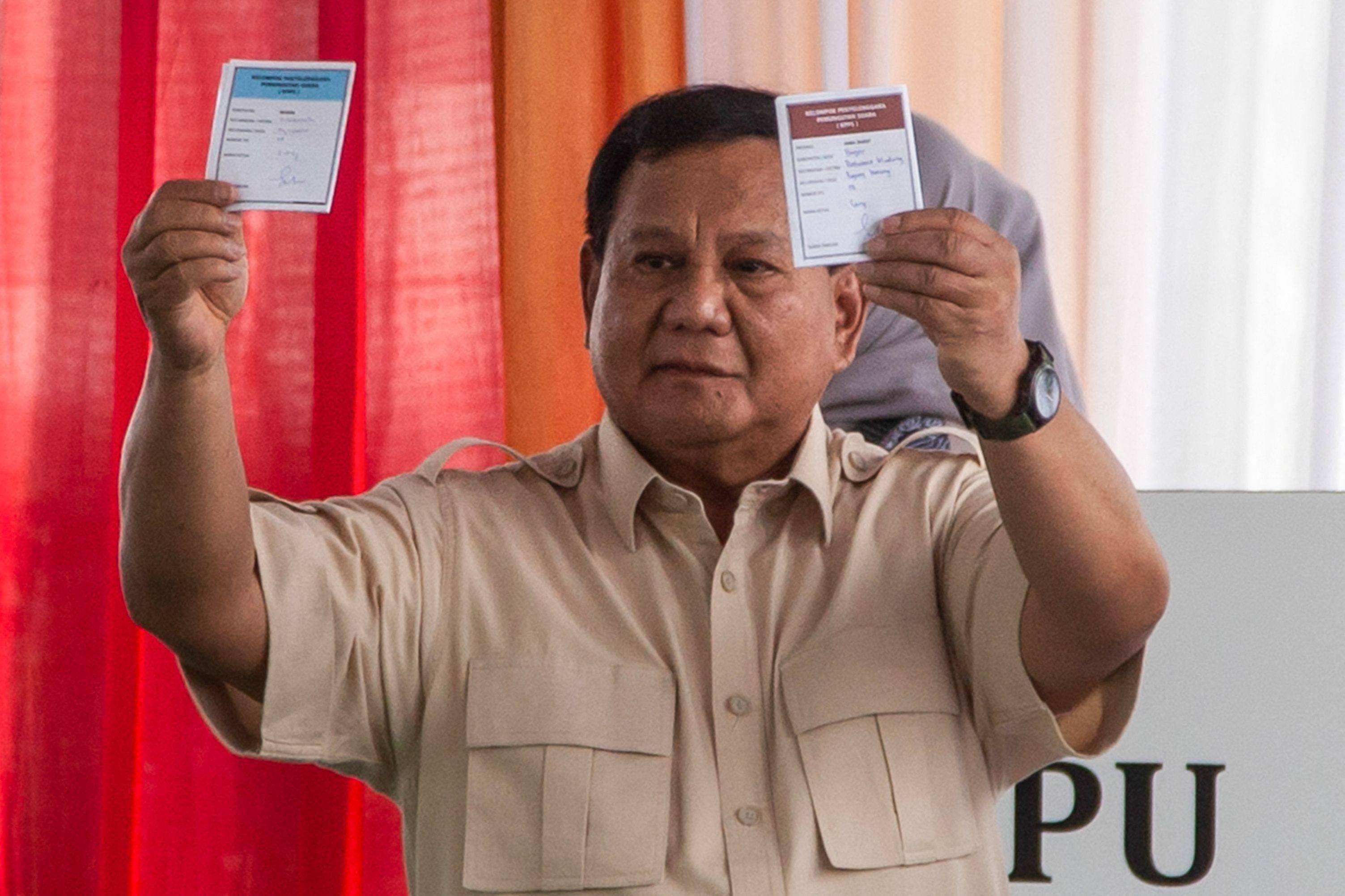 Indonesia’s President Prabowo Subianto shows the ballot papers while voting at a regional election in Bogor, West Java on Wednesday. Photo: AFP