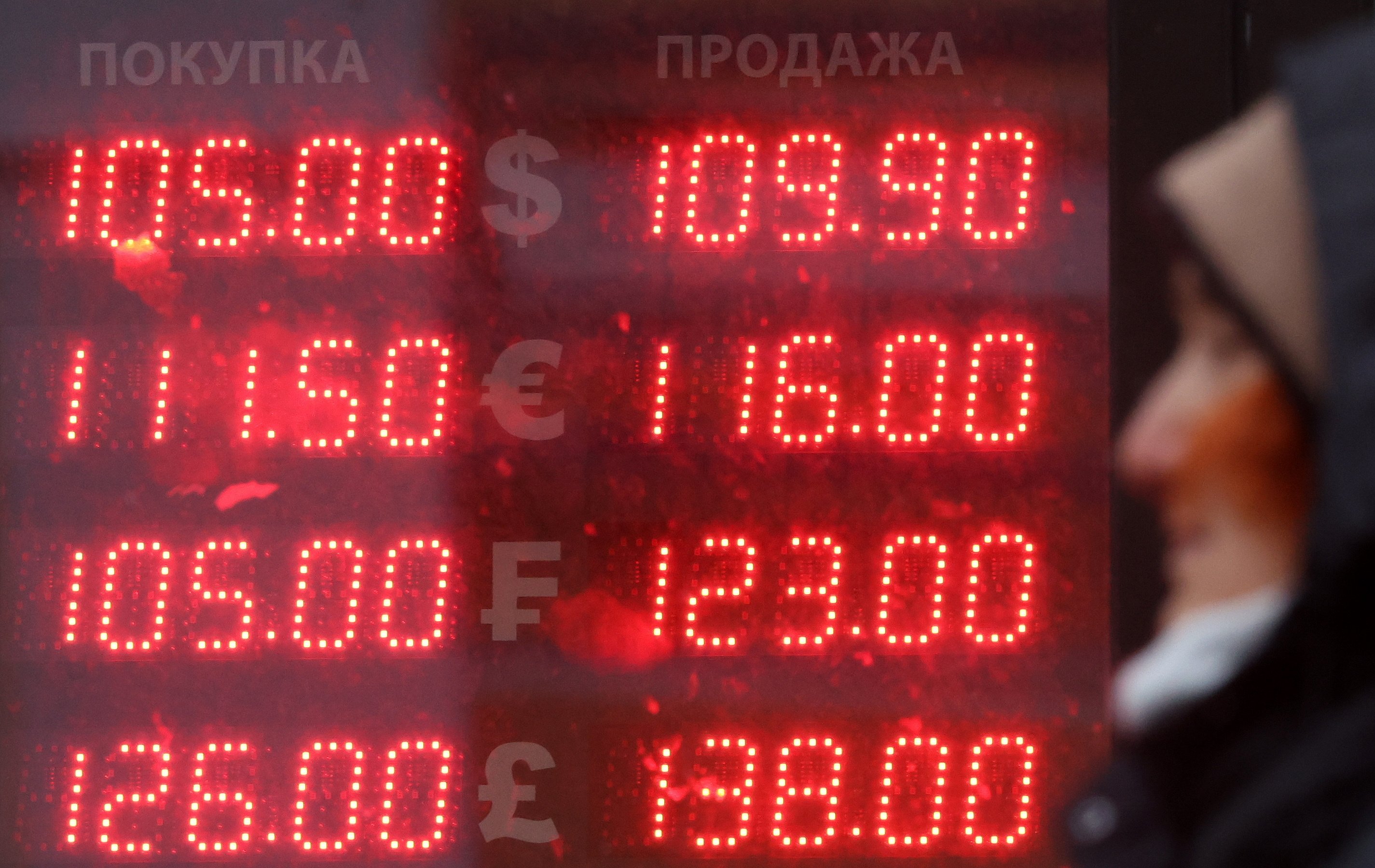 Currency exchange rates on display outside an exchange office in Moscow on Thursday. Photo: EPA-EFE