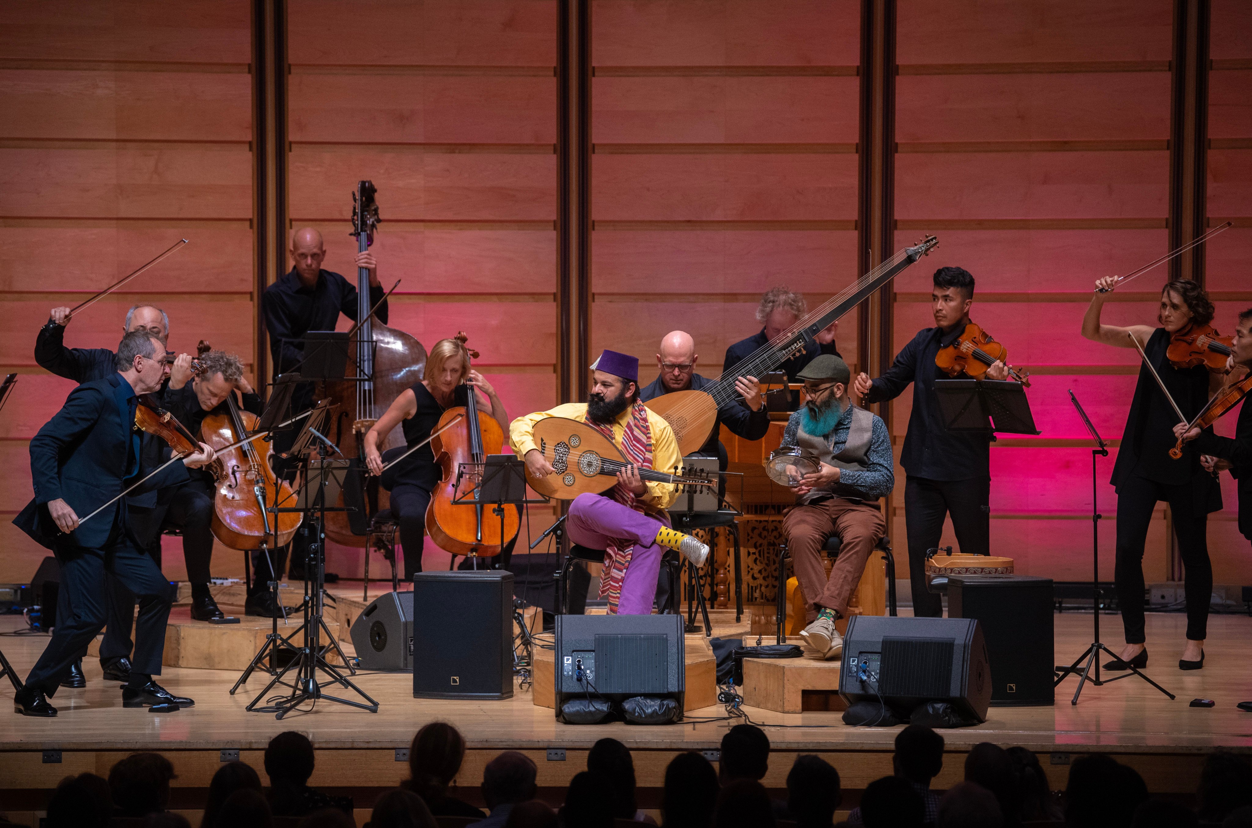 The Australian Chamber Orchestra joined by oud virtuoso Joseph Tawadros (seated; purple trousers). Photo: Nic Walker