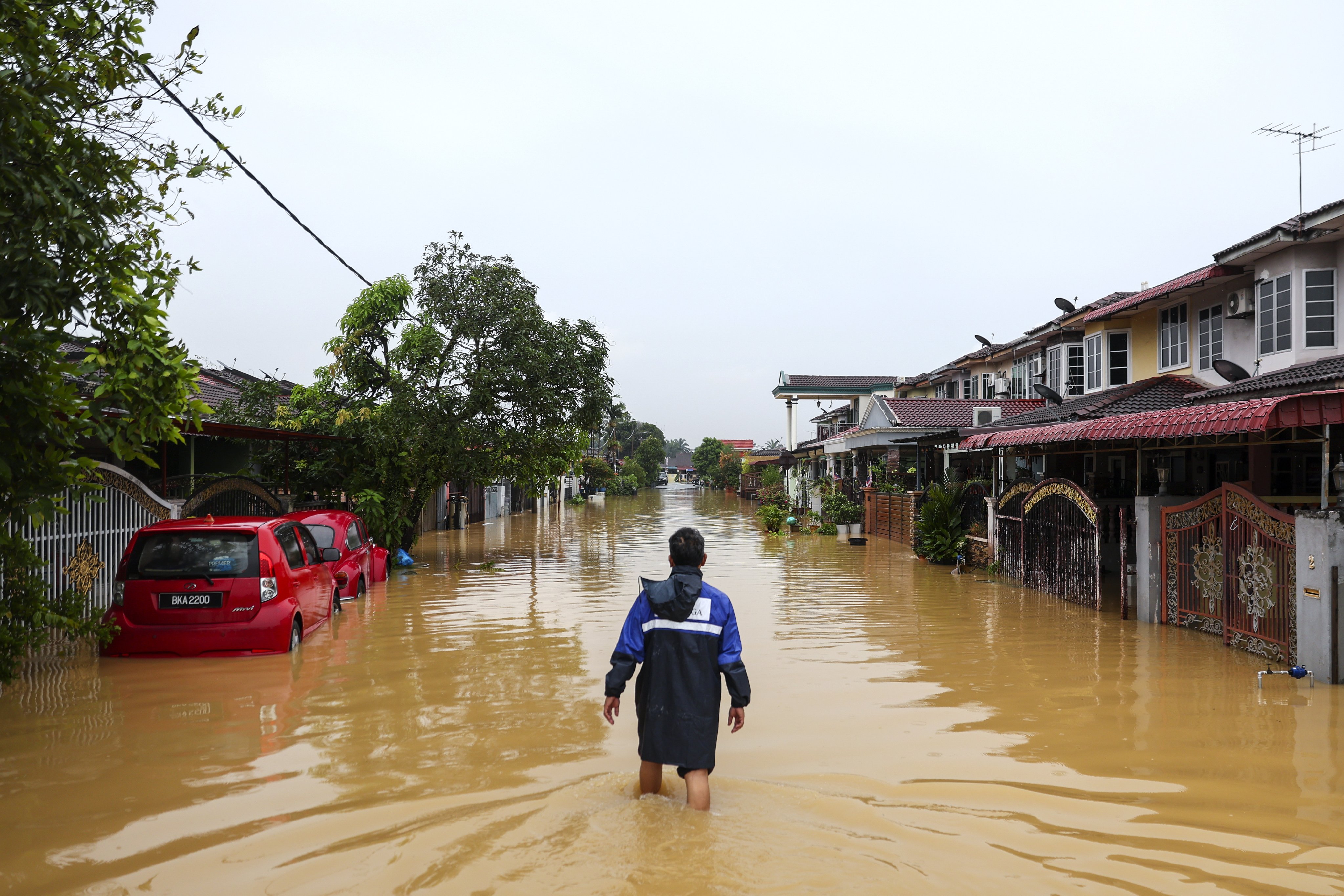 A man wades through a flooded area in Klang, Malaysia’s Selangor state, on Friday. Photo: EPA-EFE